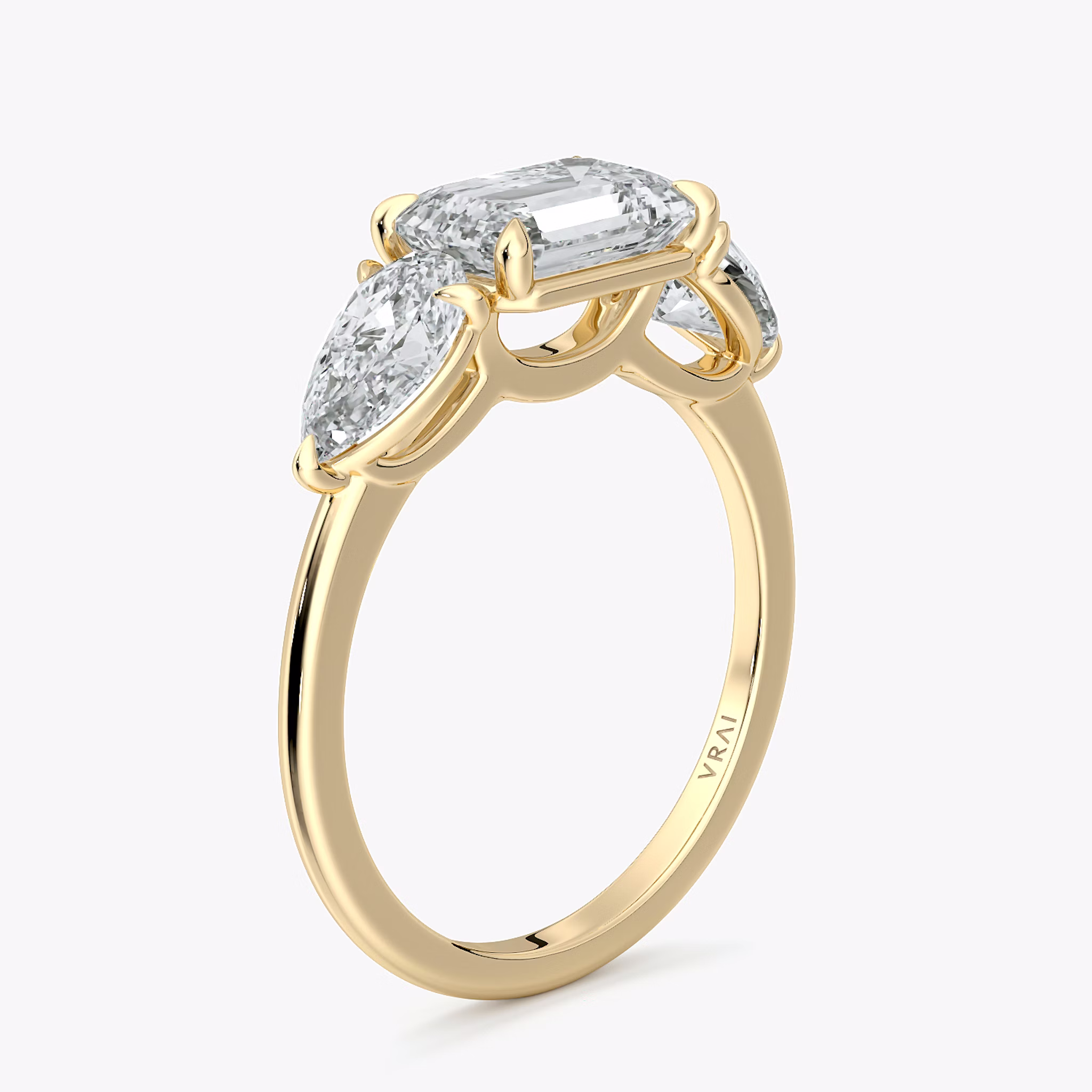 The Three Stone | Emerald | 18k | Yellow Gold | bandAccent: Plain | diamondOrientation: horizontal | sideStoneCarat: 0.50ct | sideStoneShape: Pear | caratWeight: other