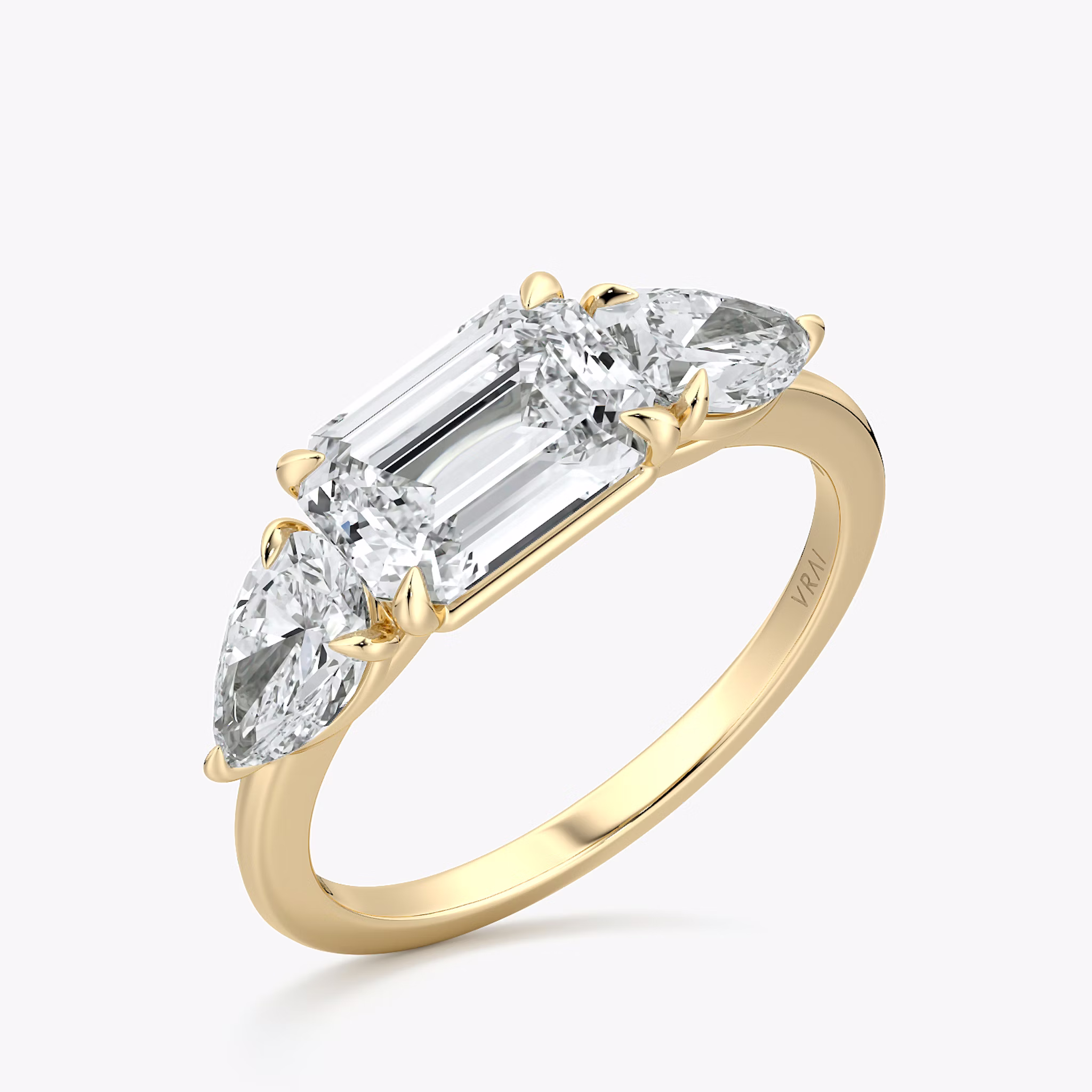 The Three Stone | Emerald | 18k | Yellow Gold | bandAccent: Plain | diamondOrientation: horizontal | sideStoneCarat: 0.50ct | sideStoneShape: Pear | caratWeight: other