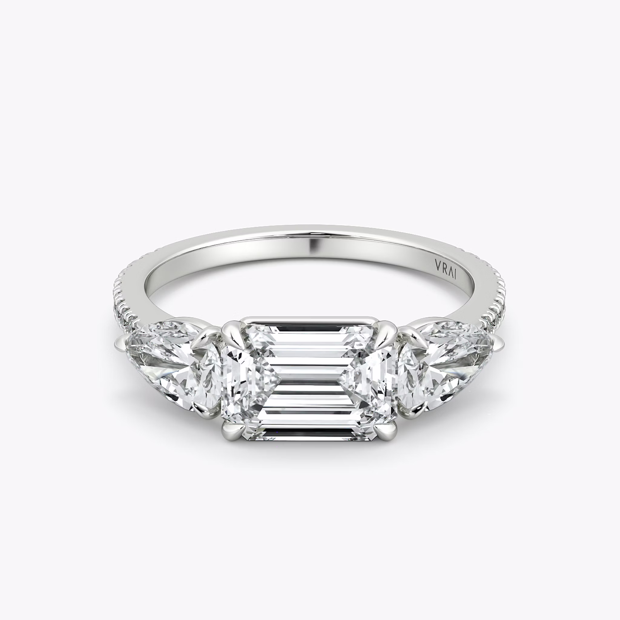 The Three Stone | Emerald | Platinum | bandAccent: Pavé | diamondOrientation: horizontal | sideStoneCarat: 0.50ct | sideStoneShape: Pear | caratWeight: other