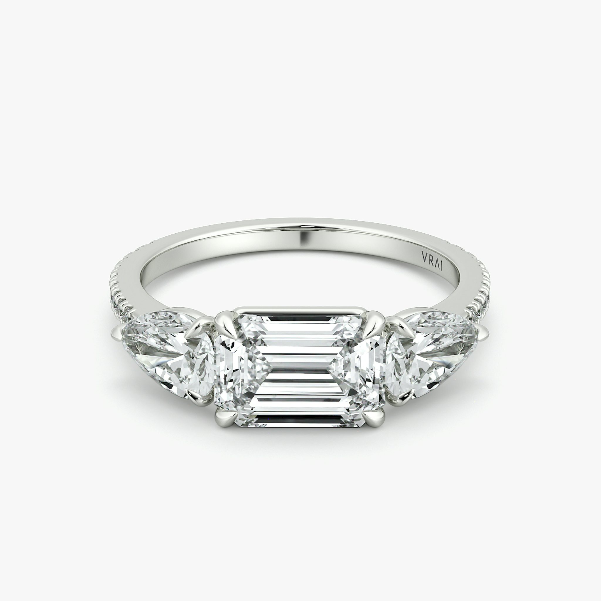 The Three Stone | Emerald | Platinum | bandAccent: Pavé | diamondOrientation: horizontal | sideStoneCarat: 0.50ct | sideStoneShape: Pear | caratWeight: other