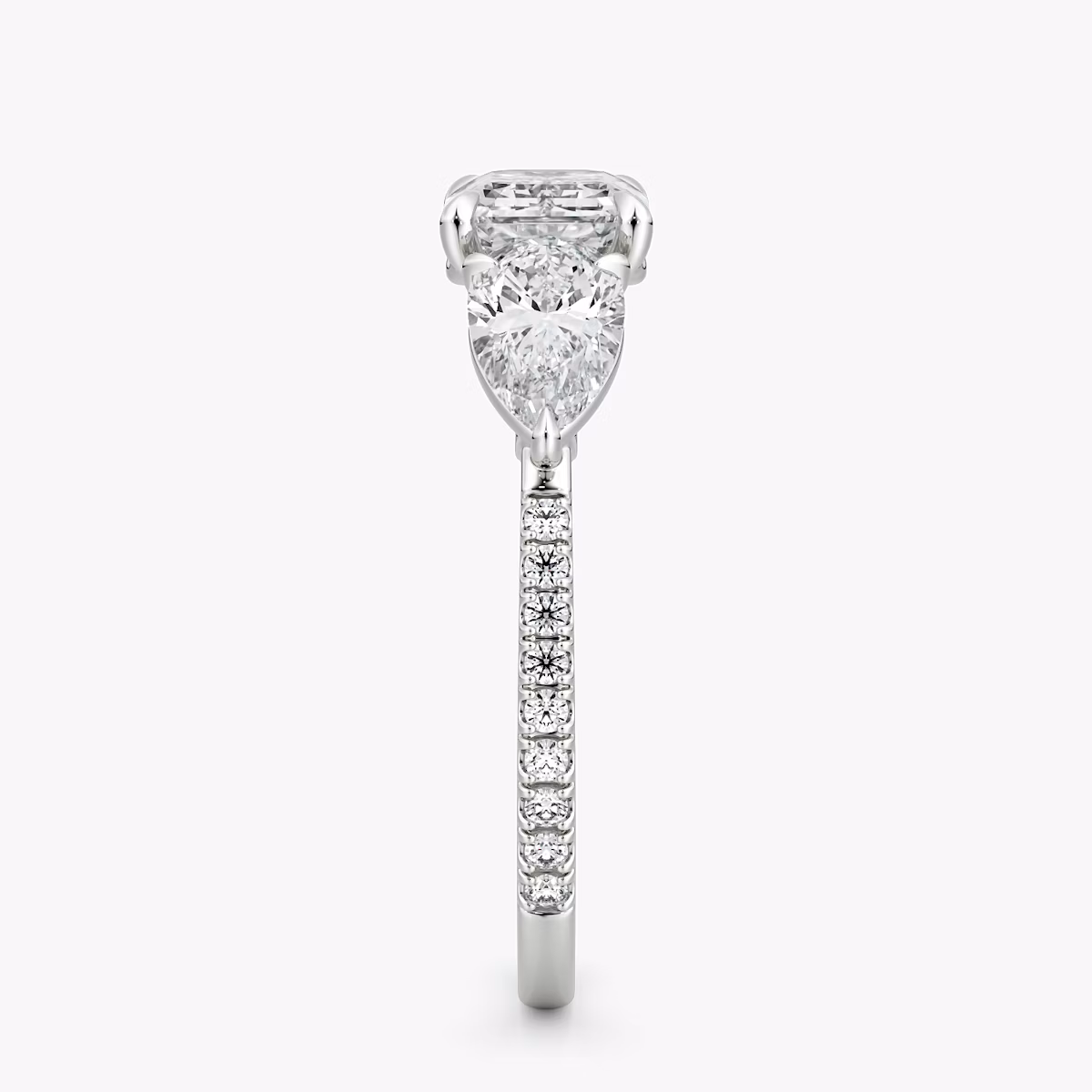 The Three Stone | Emerald | Platinum | bandAccent: Pavé | diamondOrientation: horizontal | sideStoneCarat: 0.50ct | sideStoneShape: Pear | caratWeight: other