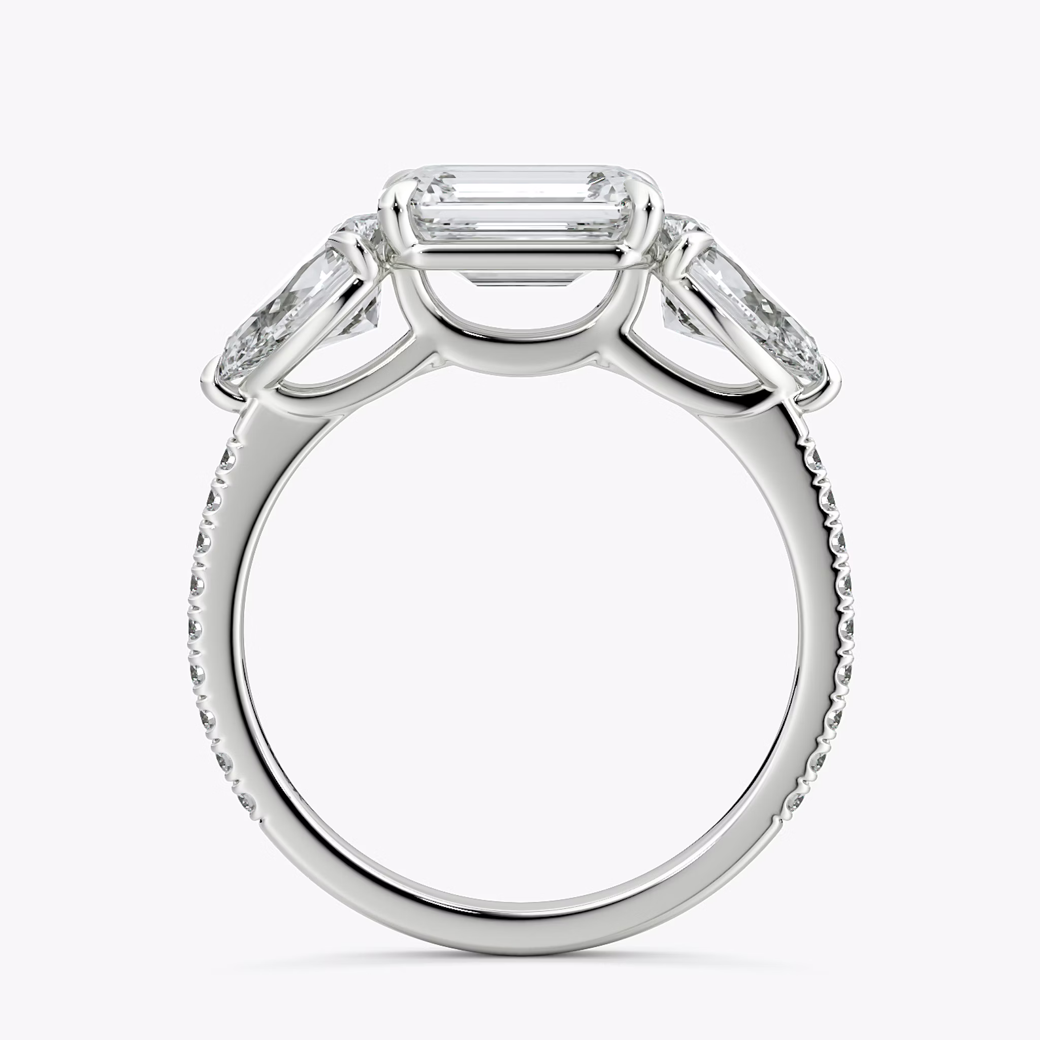 The Three Stone | Emerald | Platinum | bandAccent: Pavé | diamondOrientation: horizontal | sideStoneCarat: 0.50ct | sideStoneShape: Pear | caratWeight: other