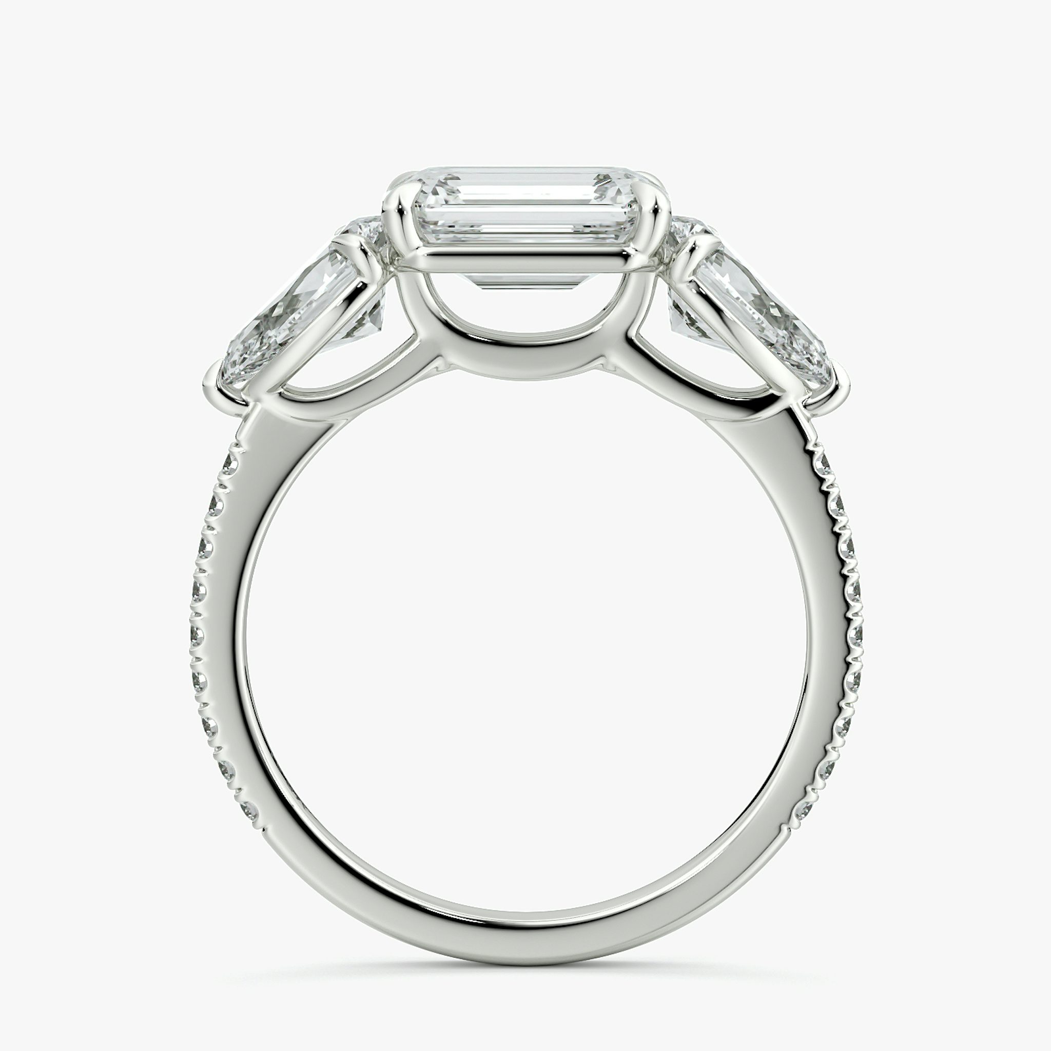 The Three Stone | Emerald | Platinum | bandAccent: Pavé | diamondOrientation: horizontal | sideStoneCarat: 0.50ct | sideStoneShape: Pear | caratWeight: other