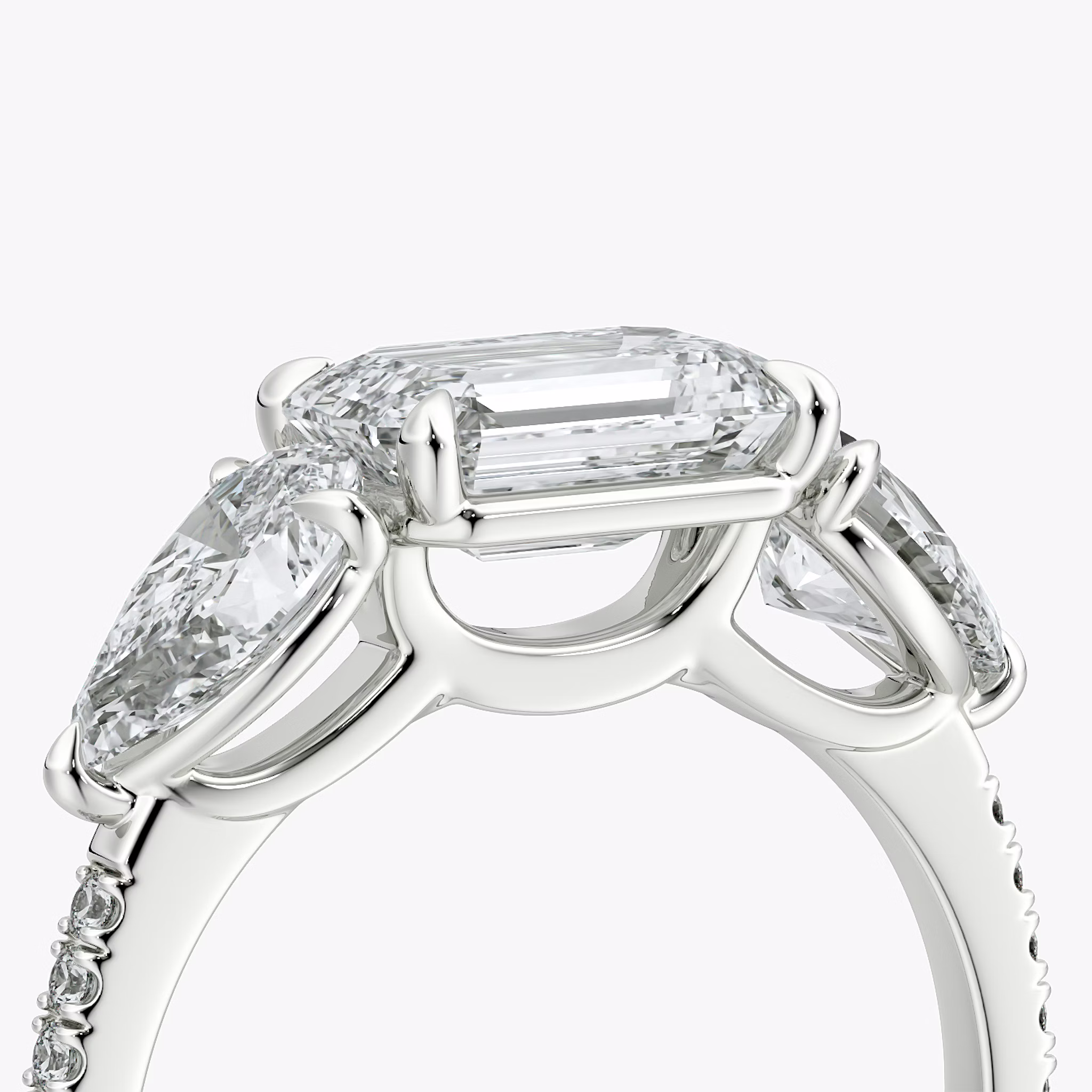 The Three Stone | Emerald | Platinum | bandAccent: Pavé | diamondOrientation: horizontal | sideStoneCarat: 0.50ct | sideStoneShape: Pear | caratWeight: other
