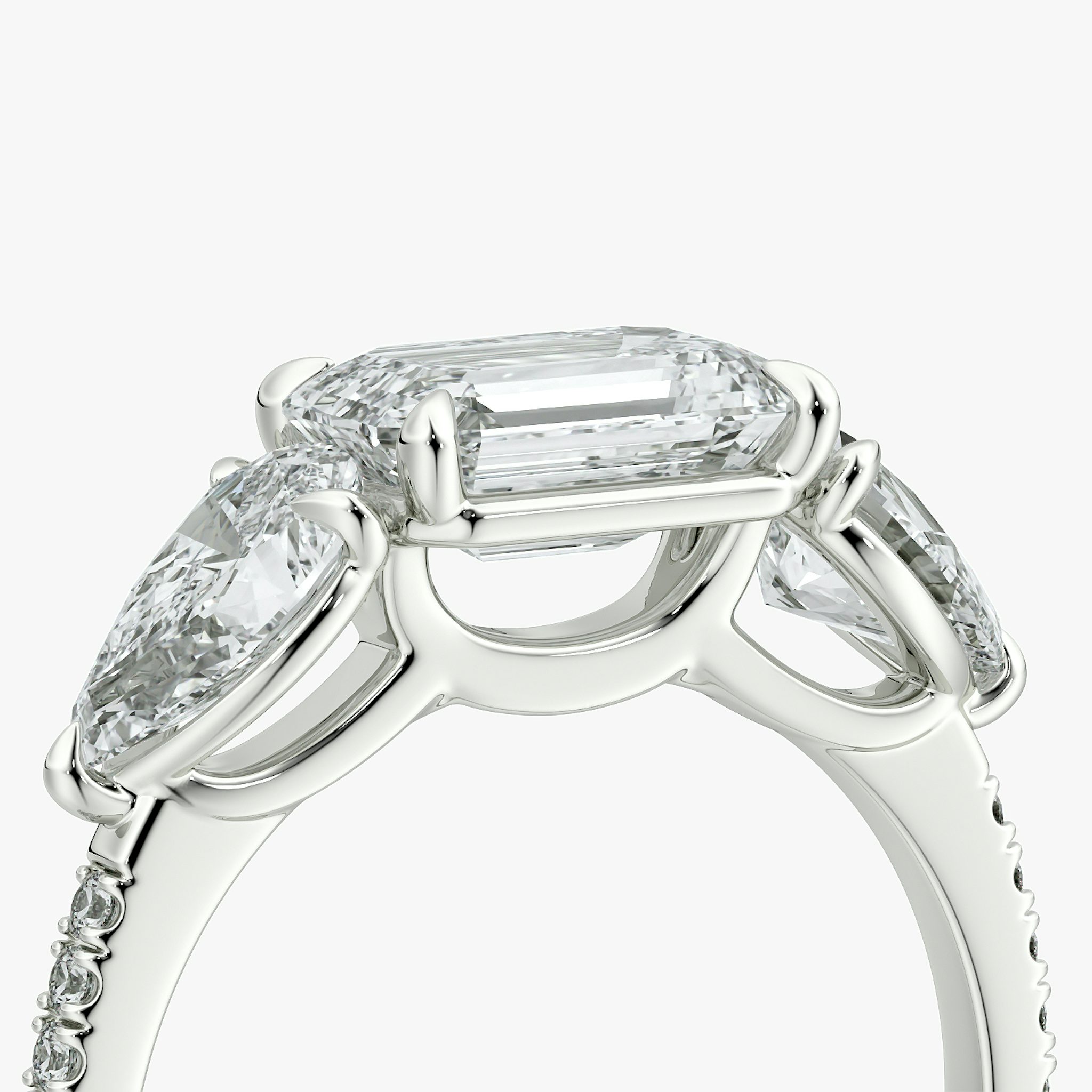 The Three Stone | Emerald | Platinum | bandAccent: Pavé | diamondOrientation: horizontal | sideStoneCarat: 0.50ct | sideStoneShape: Pear | caratWeight: other