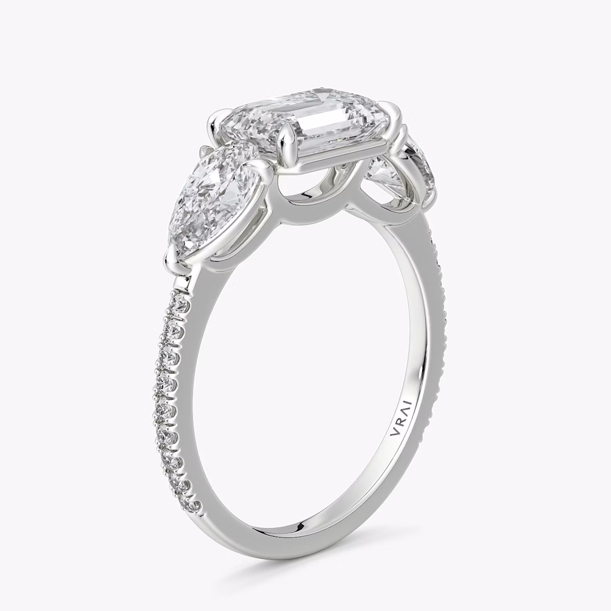 The Three Stone | Emerald | Platinum | bandAccent: Pavé | diamondOrientation: horizontal | sideStoneCarat: 0.50ct | sideStoneShape: Pear | caratWeight: other