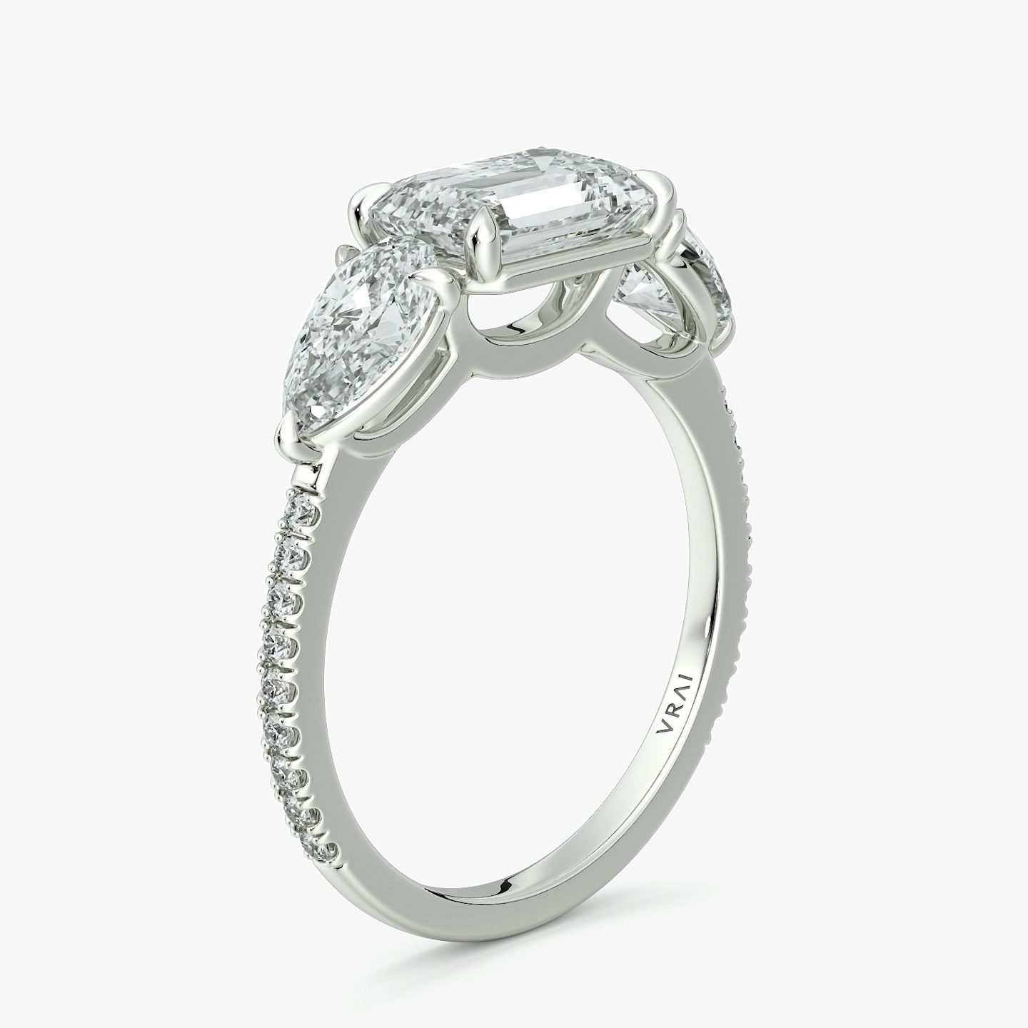 The Three Stone | Emerald | 18k | White Gold | bandAccent: Pavé | diamondOrientation: horizontal | sideStoneCarat: 0.50ct | sideStoneShape: Pear | caratWeight: other