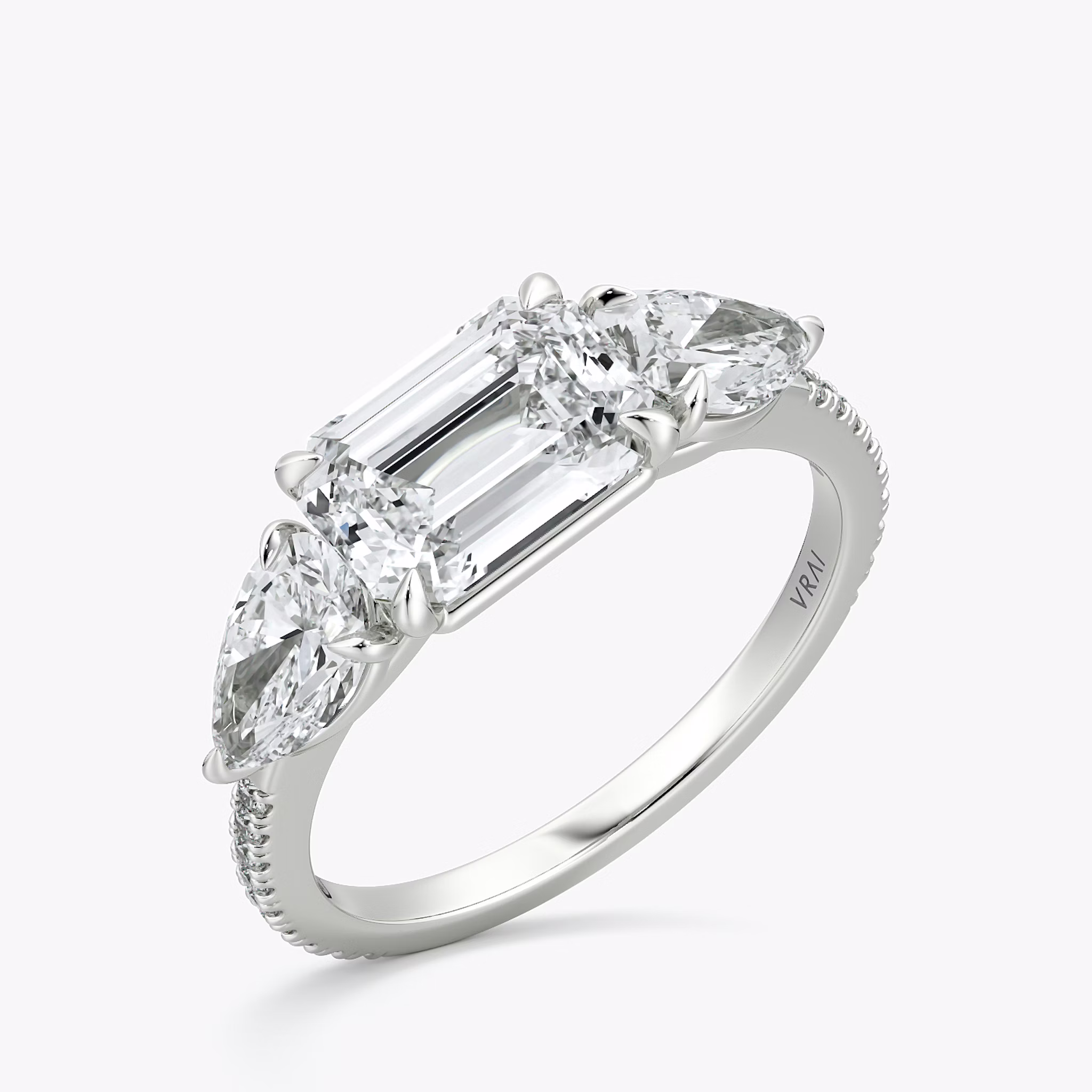 The Three Stone | Emerald | Platinum | bandAccent: Pavé | diamondOrientation: horizontal | sideStoneCarat: 0.50ct | sideStoneShape: Pear | caratWeight: other