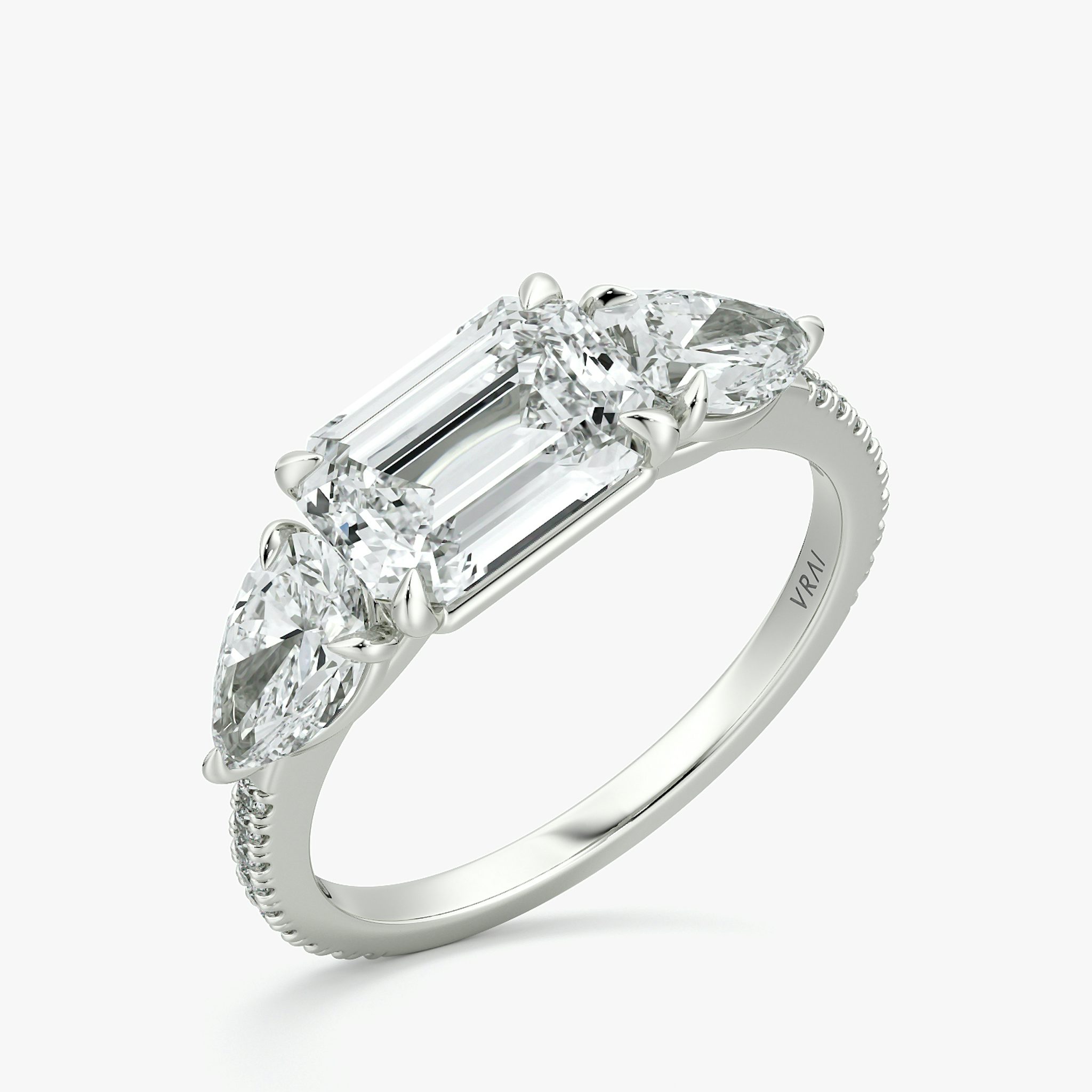 The Three Stone | Emerald | Platinum | bandAccent: Pavé | diamondOrientation: horizontal | sideStoneCarat: 0.50ct | sideStoneShape: Pear | caratWeight: other