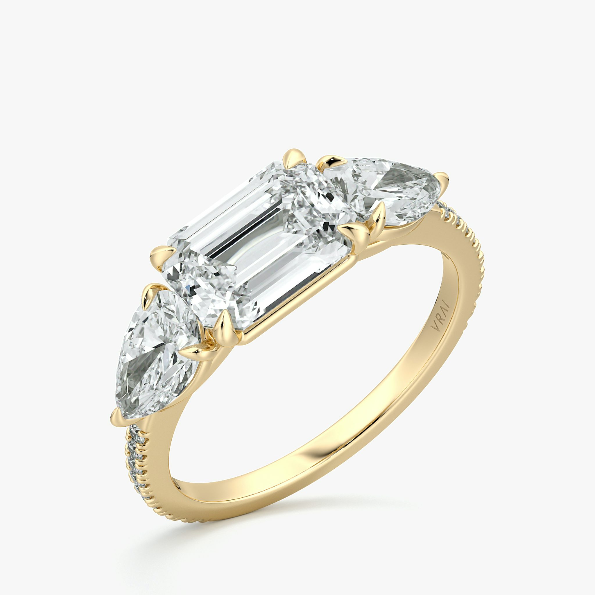 The Three Stone | Emerald | 18k | Yellow Gold | bandAccent: Pavé | diamondOrientation: horizontal | sideStoneCarat: 0.50ct | sideStoneShape: Pear | caratWeight: other