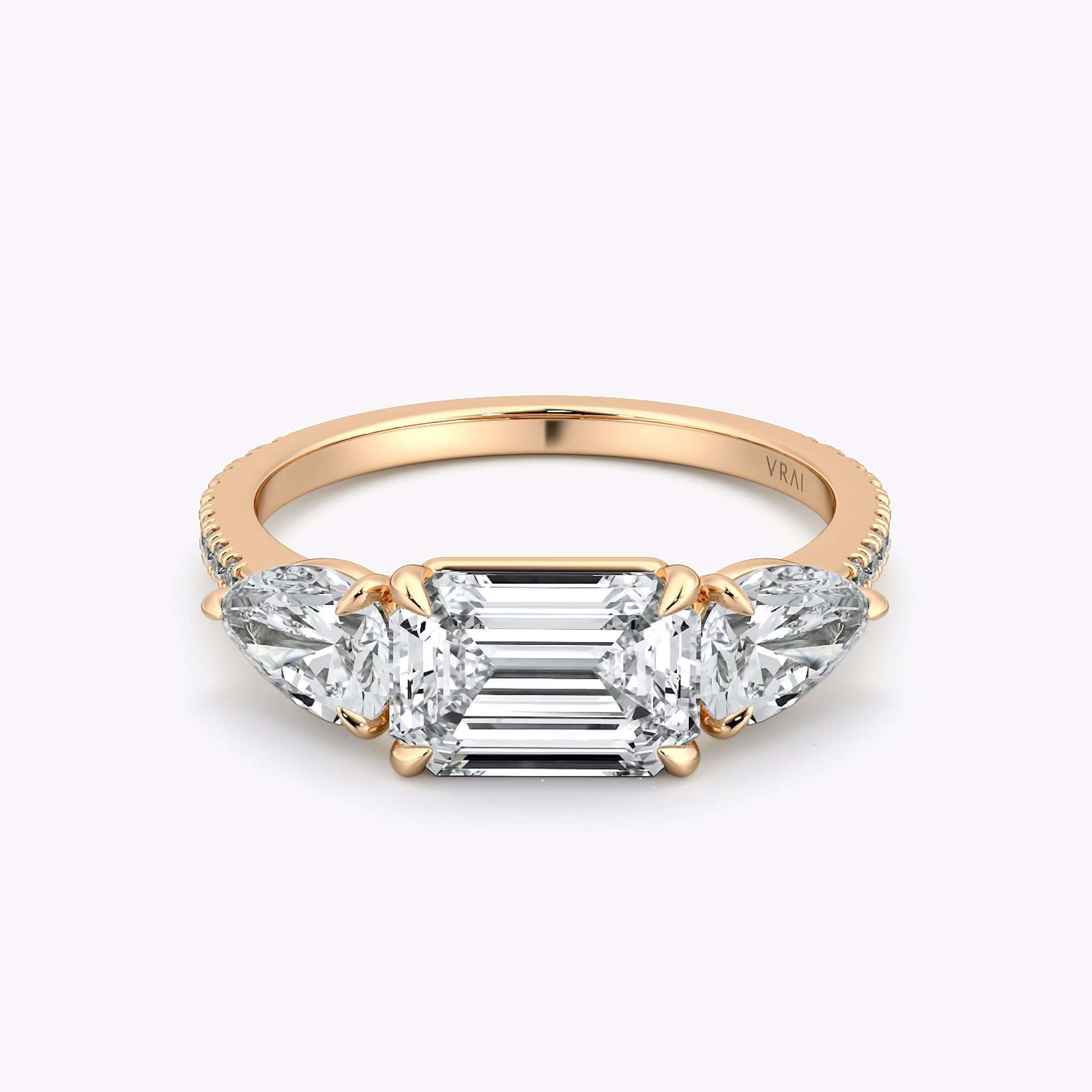 The Three Stone | Emerald | 14k | Rose Gold | bandAccent: Pavé | diamondOrientation: horizontal | sideStoneCarat: 0.50ct | sideStoneShape: Pear | caratWeight: other