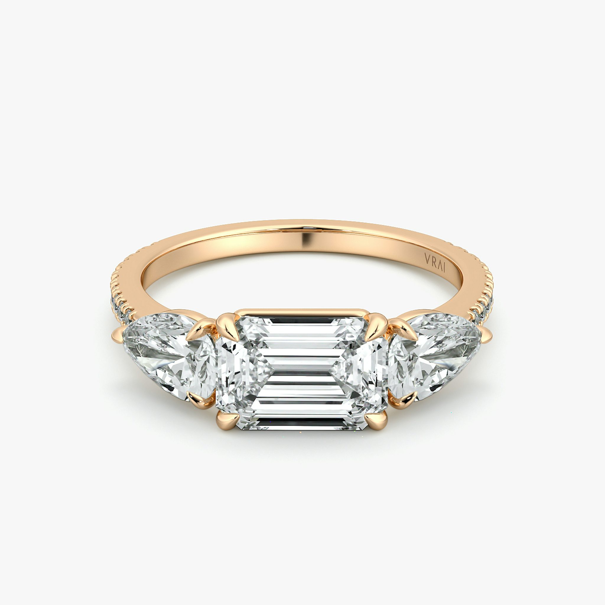 The Three Stone | Emerald | 14k | Rose Gold | bandAccent: Pavé | diamondOrientation: horizontal | sideStoneCarat: 0.50ct | sideStoneShape: Pear | caratWeight: other