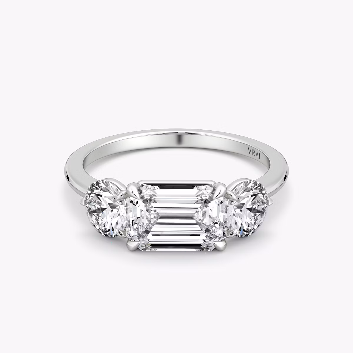 The Three Stone | Emerald | Platinum | bandAccent: Plain | diamondOrientation: horizontal | sideStoneCarat: 0.50ct | sideStoneShape: Round Brilliant | caratWeight: other