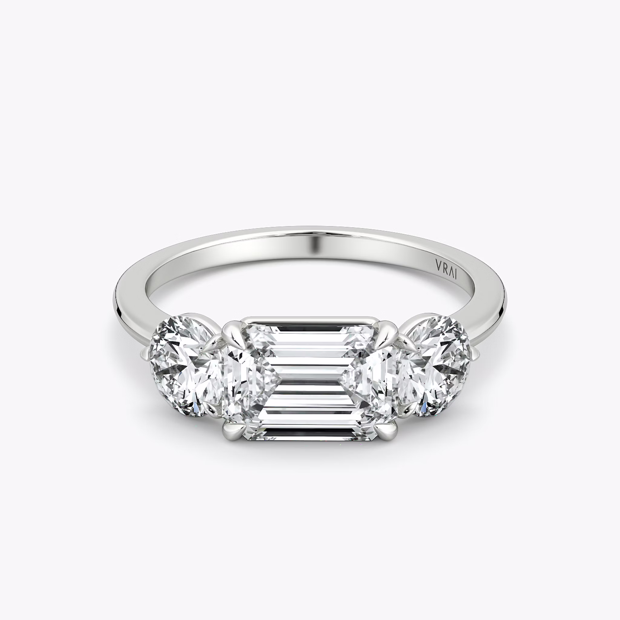 The Three Stone | Emerald | 18k | White Gold | bandAccent: Plain | diamondOrientation: horizontal | sideStoneCarat: 0.50ct | sideStoneShape: Round Brilliant | caratWeight: other