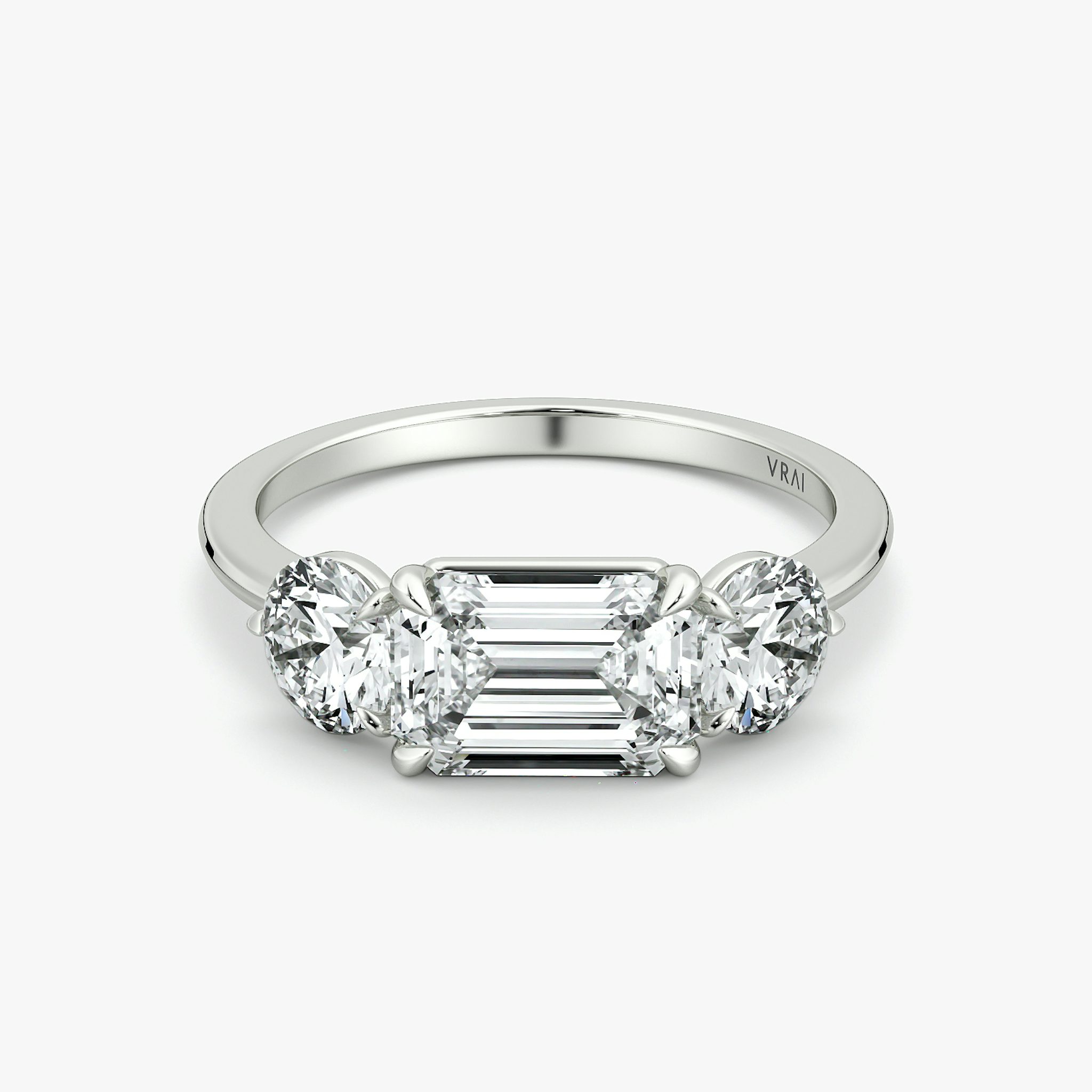 The Three Stone | Emerald | 18k | White Gold | bandAccent: Plain | diamondOrientation: horizontal | sideStoneCarat: 0.50ct | sideStoneShape: Round Brilliant | caratWeight: other