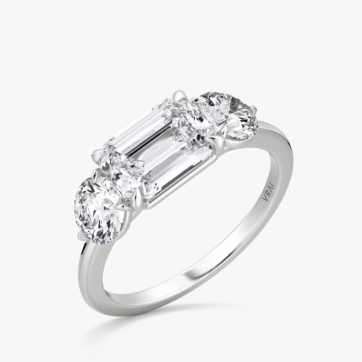 The Three Stone | Emerald | Platinum | bandAccent: Plain | diamondOrientation: horizontal | sideStoneCarat: 0.50ct | sideStoneShape: Round Brilliant | caratWeight: other