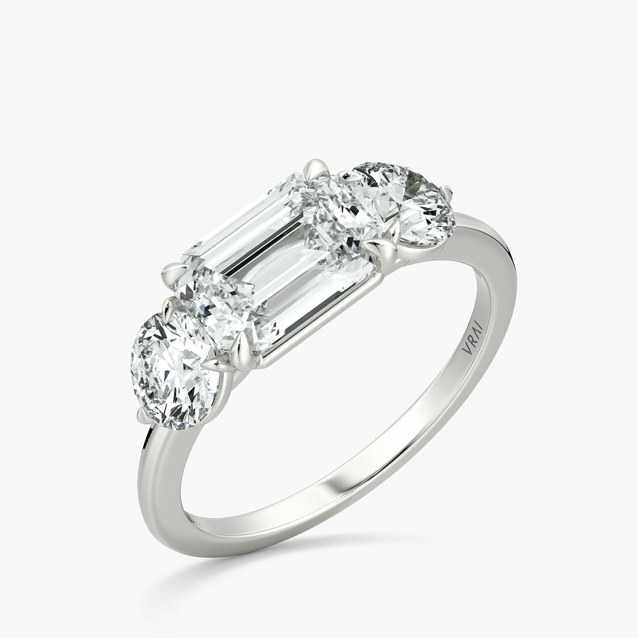 The Three Stone | Emerald | 18k | White Gold | bandAccent: Plain | diamondOrientation: horizontal | sideStoneCarat: 0.50ct | sideStoneShape: Round Brilliant | caratWeight: other