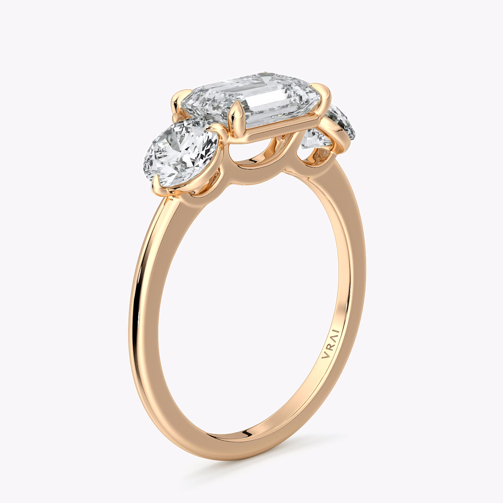 The Three Stone | Emerald | 14k | Rose Gold | bandAccent: Plain | diamondOrientation: horizontal | sideStoneCarat: 0.50ct | sideStoneShape: Round Brilliant | caratWeight: other