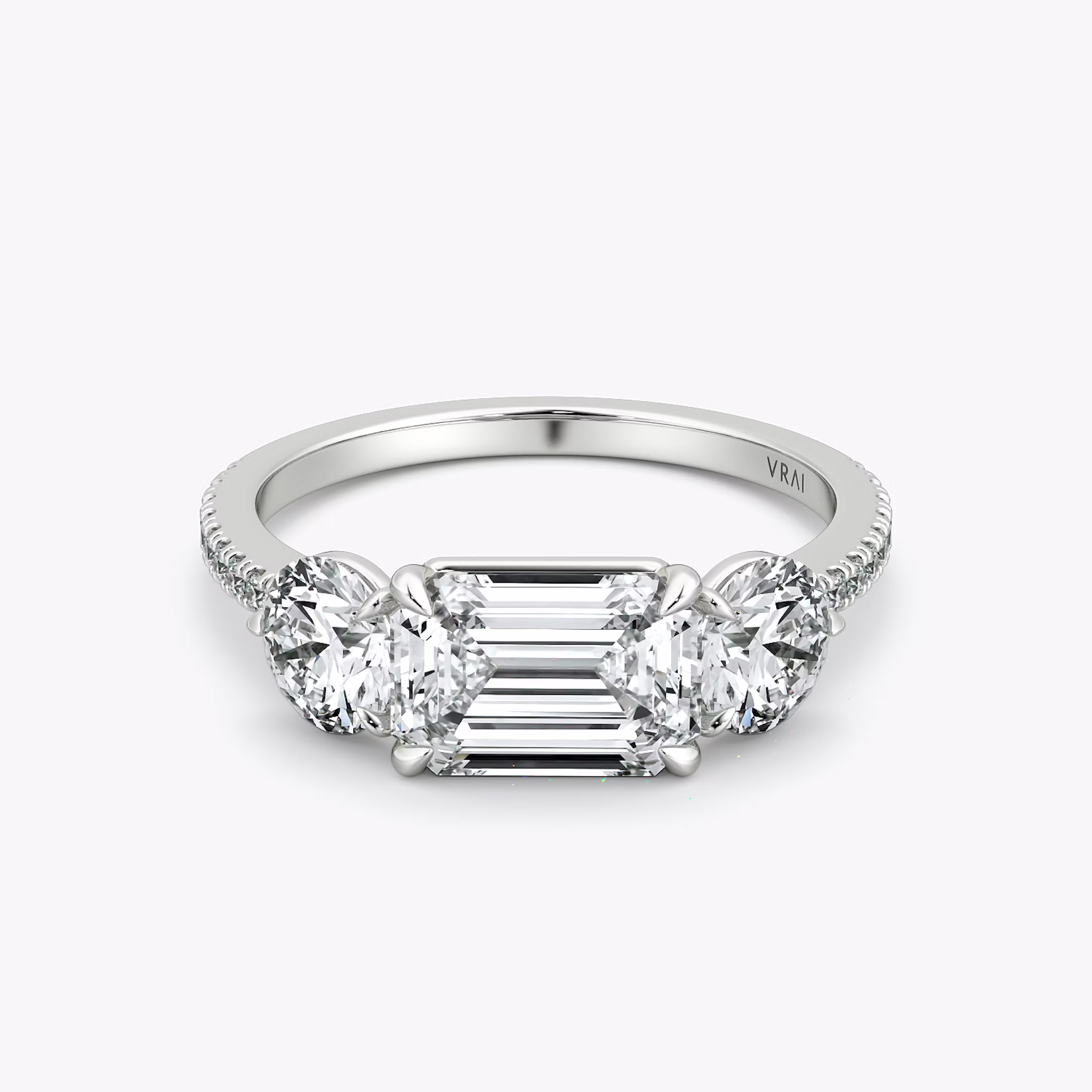 The Three Stone | Emerald | 18k | White Gold | bandAccent: Pavé | diamondOrientation: horizontal | sideStoneCarat: 0.50ct | sideStoneShape: Round Brilliant | caratWeight: other