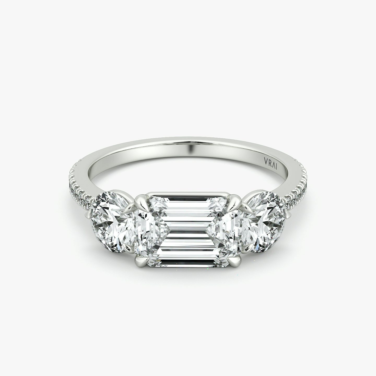 The Three Stone | Emerald | Platinum | bandAccent: Pavé | diamondOrientation: horizontal | sideStoneCarat: 0.50ct | sideStoneShape: Round Brilliant | caratWeight: other