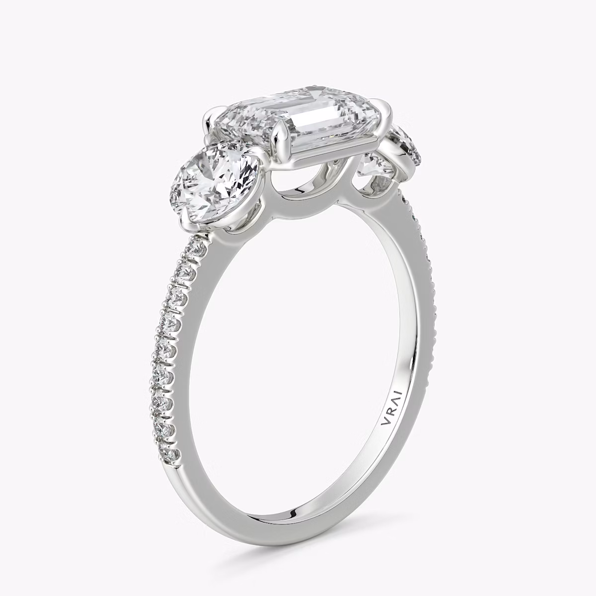 The Three Stone | Emerald | Platinum | bandAccent: Pavé | diamondOrientation: horizontal | sideStoneCarat: 0.50ct | sideStoneShape: Round Brilliant | caratWeight: other