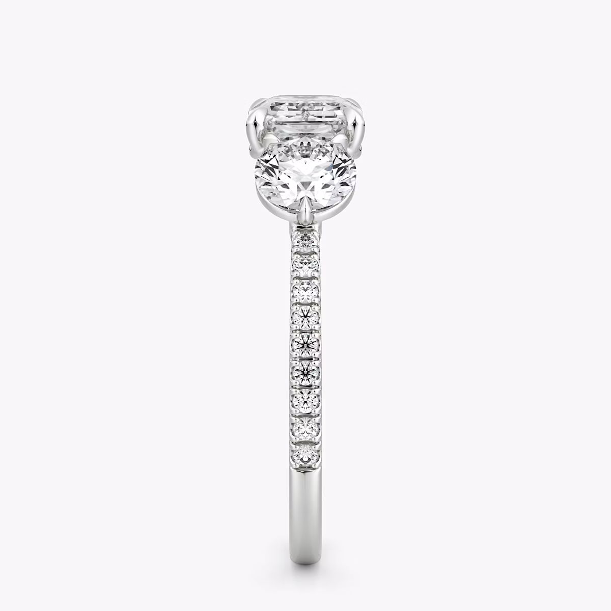 The Three Stone | Emerald | Platinum | bandAccent: Pavé | diamondOrientation: horizontal | sideStoneCarat: 0.50ct | sideStoneShape: Round Brilliant | caratWeight: other