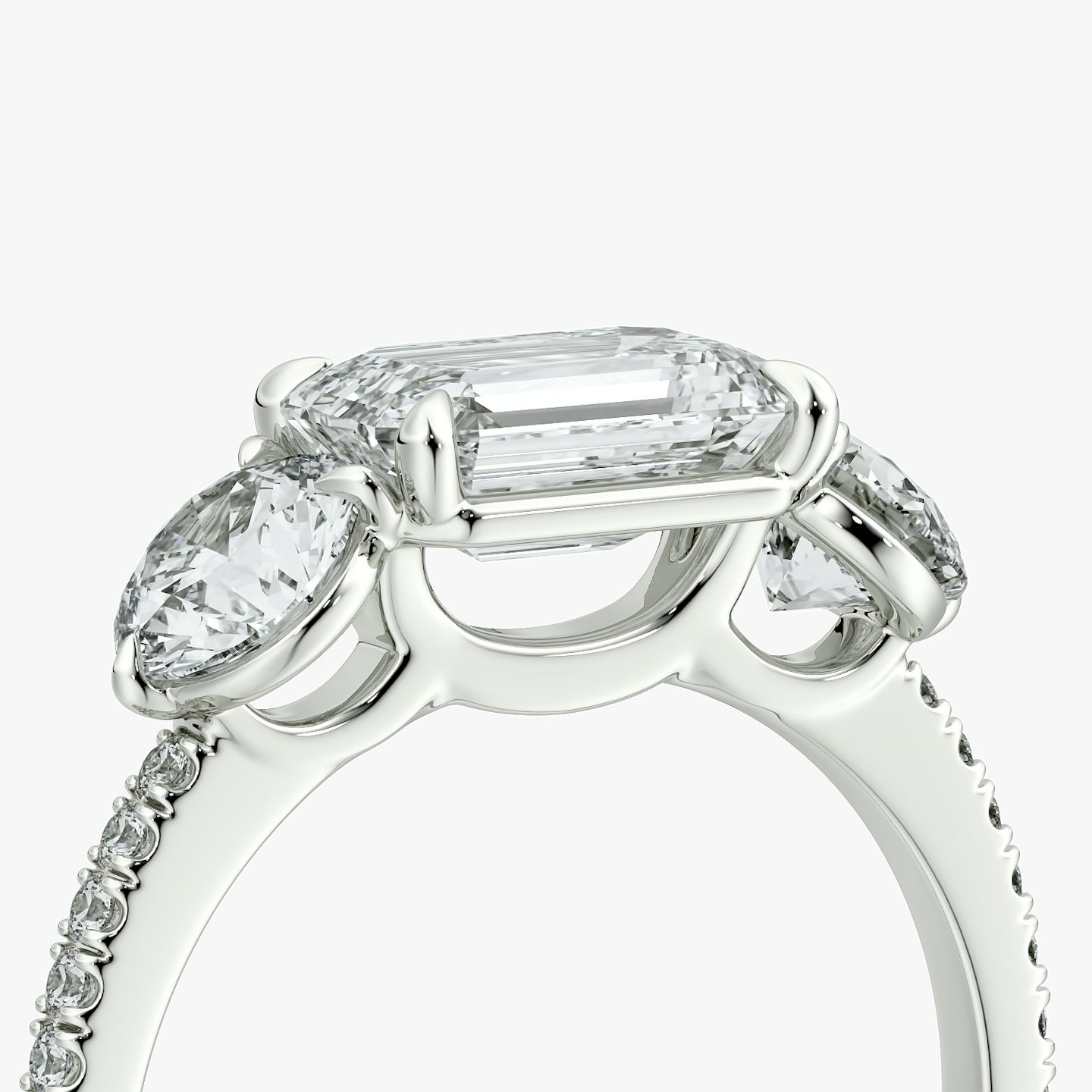 The Three Stone | Emerald | Platinum | bandAccent: Pavé | diamondOrientation: horizontal | sideStoneCarat: 0.50ct | sideStoneShape: Round Brilliant | caratWeight: other