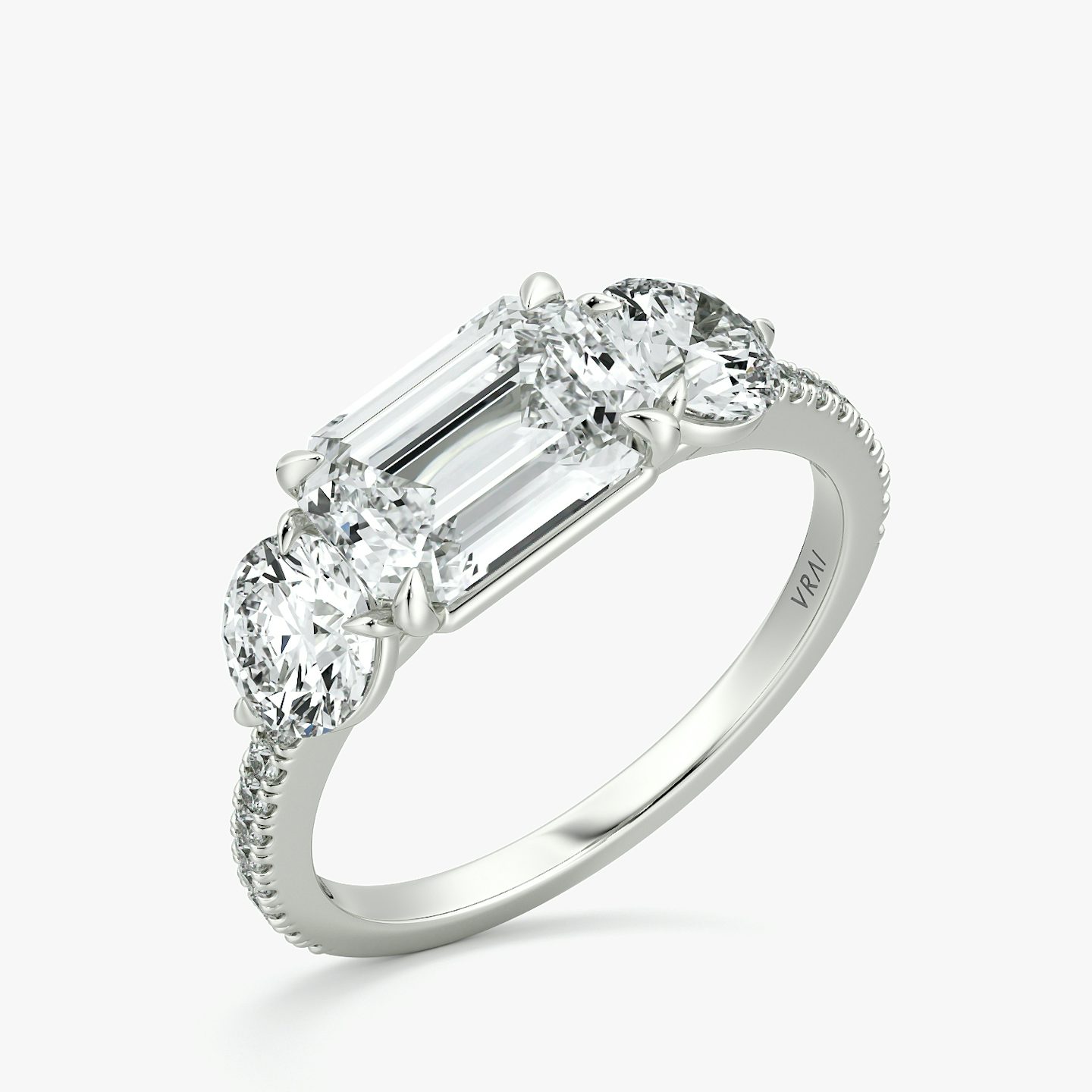 The Three Stone | Emerald | Platinum | bandAccent: Pavé | diamondOrientation: horizontal | sideStoneCarat: 0.50ct | sideStoneShape: Round Brilliant | caratWeight: other