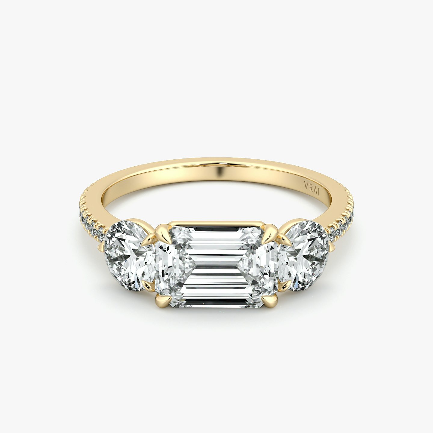 The Three Stone | Emerald | 18k | Yellow Gold | bandAccent: Pavé | diamondOrientation: horizontal | sideStoneCarat: 0.50ct | sideStoneShape: Round Brilliant | caratWeight: other