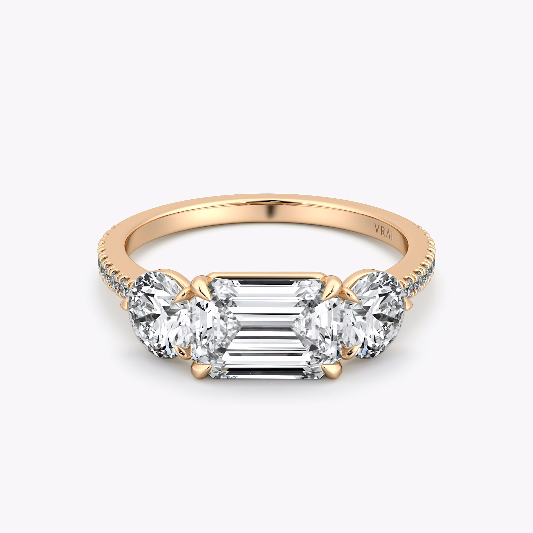 The Three Stone | Emerald | 14k | Rose Gold | bandAccent: Pavé | diamondOrientation: horizontal | sideStoneCarat: 0.50ct | sideStoneShape: Round Brilliant | caratWeight: other