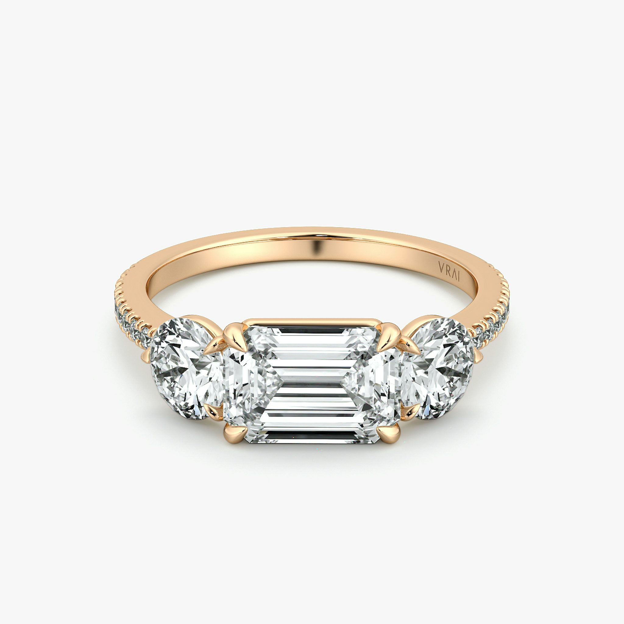 The Three Stone | Emerald | 14k | Rose Gold | bandAccent: Pavé | diamondOrientation: horizontal | sideStoneCarat: 0.50ct | sideStoneShape: Round Brilliant | caratWeight: other