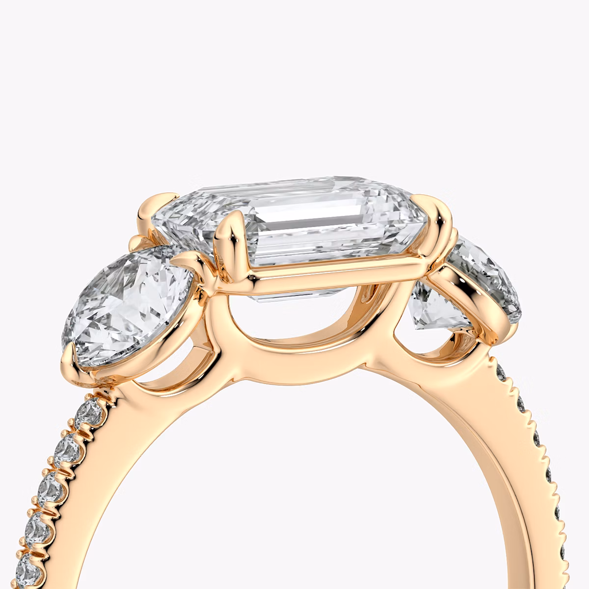 The Three Stone | Emerald | 14k | Rose Gold | bandAccent: Pavé | diamondOrientation: horizontal | sideStoneCarat: 0.50ct | sideStoneShape: Round Brilliant | caratWeight: other