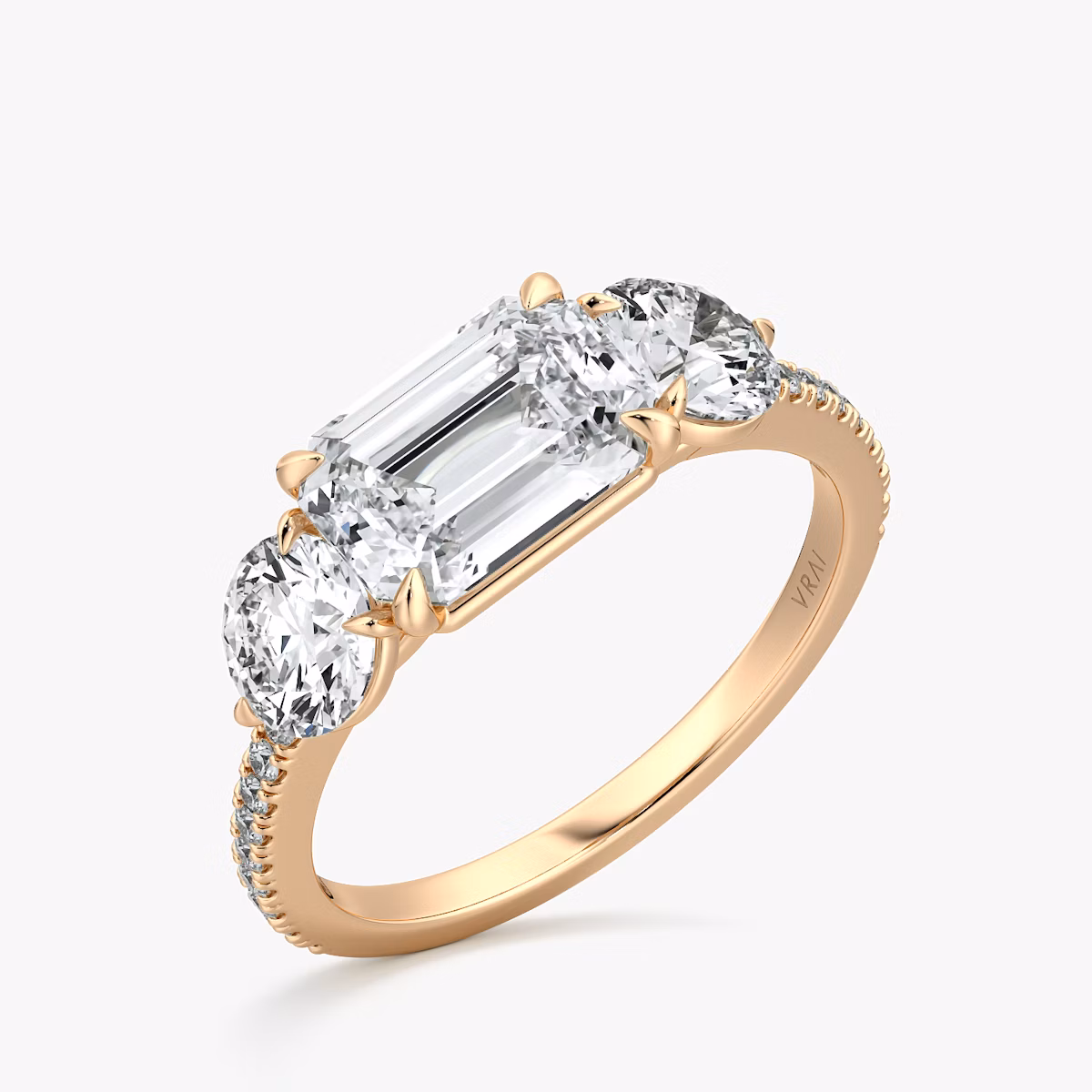 The Three Stone | Emerald | 14k | Rose Gold | bandAccent: Pavé | diamondOrientation: horizontal | sideStoneCarat: 0.50ct | sideStoneShape: Round Brilliant | caratWeight: other