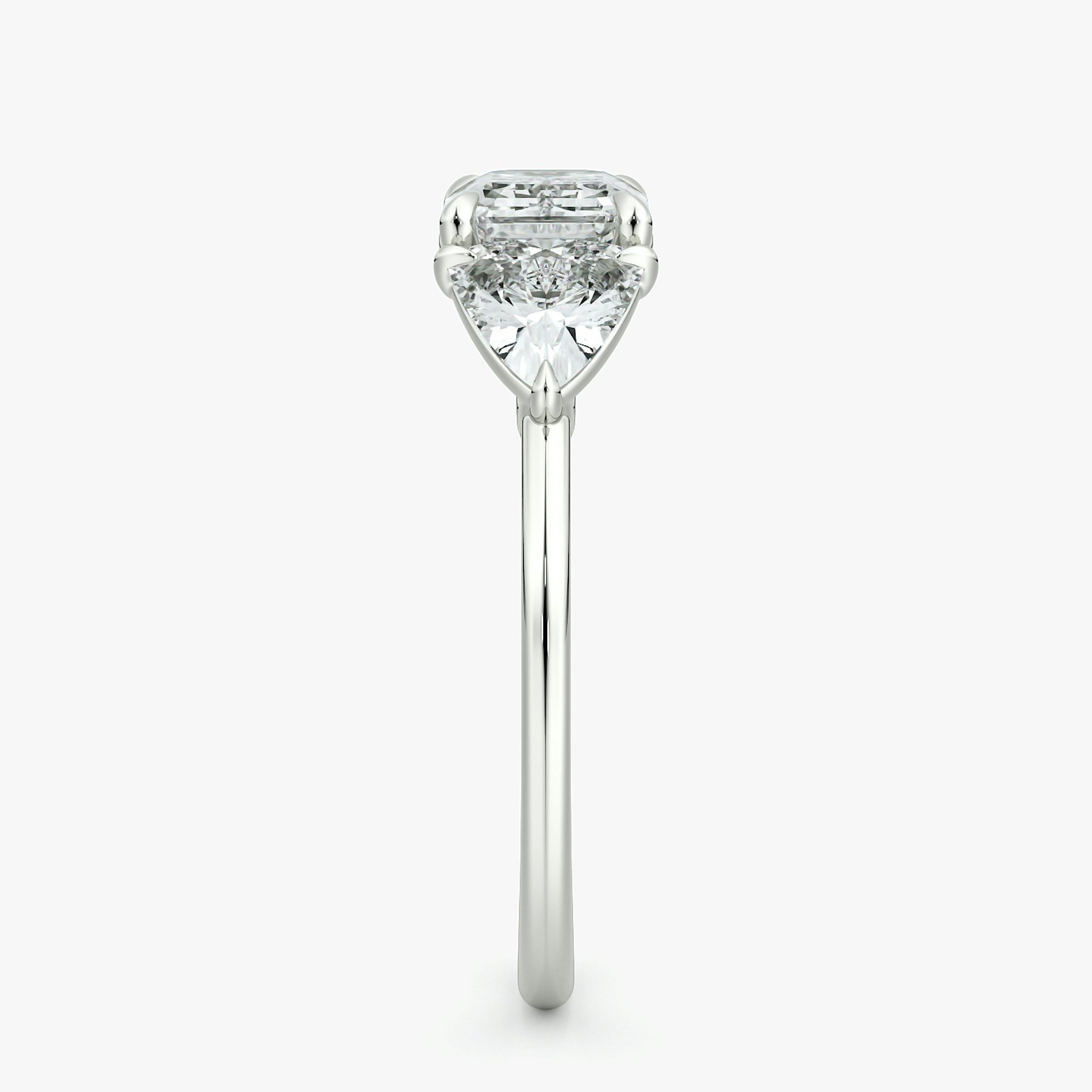 The Three Stone | Emerald | 18k | White Gold | bandAccent: Plain | diamondOrientation: horizontal | sideStoneCarat: 0.50ct | sideStoneShape: Trillion | caratWeight: other