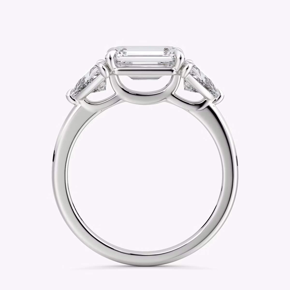 The Three Stone | Emerald | Platinum | bandAccent: Plain | diamondOrientation: horizontal | sideStoneCarat: 0.50ct | sideStoneShape: Trillion | caratWeight: other