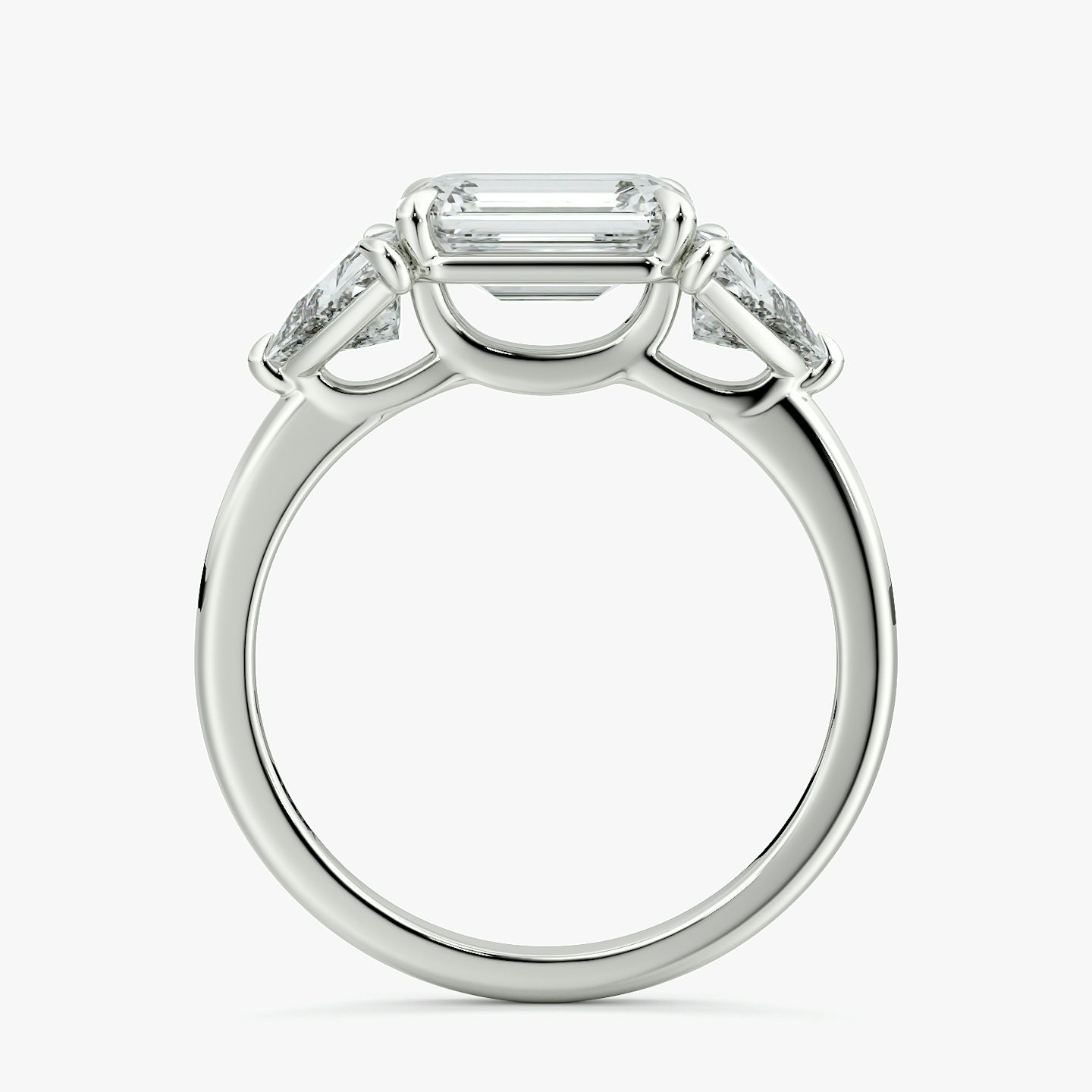 The Three Stone | Emerald | Platinum | bandAccent: Plain | diamondOrientation: horizontal | sideStoneCarat: 0.50ct | sideStoneShape: Trillion | caratWeight: other