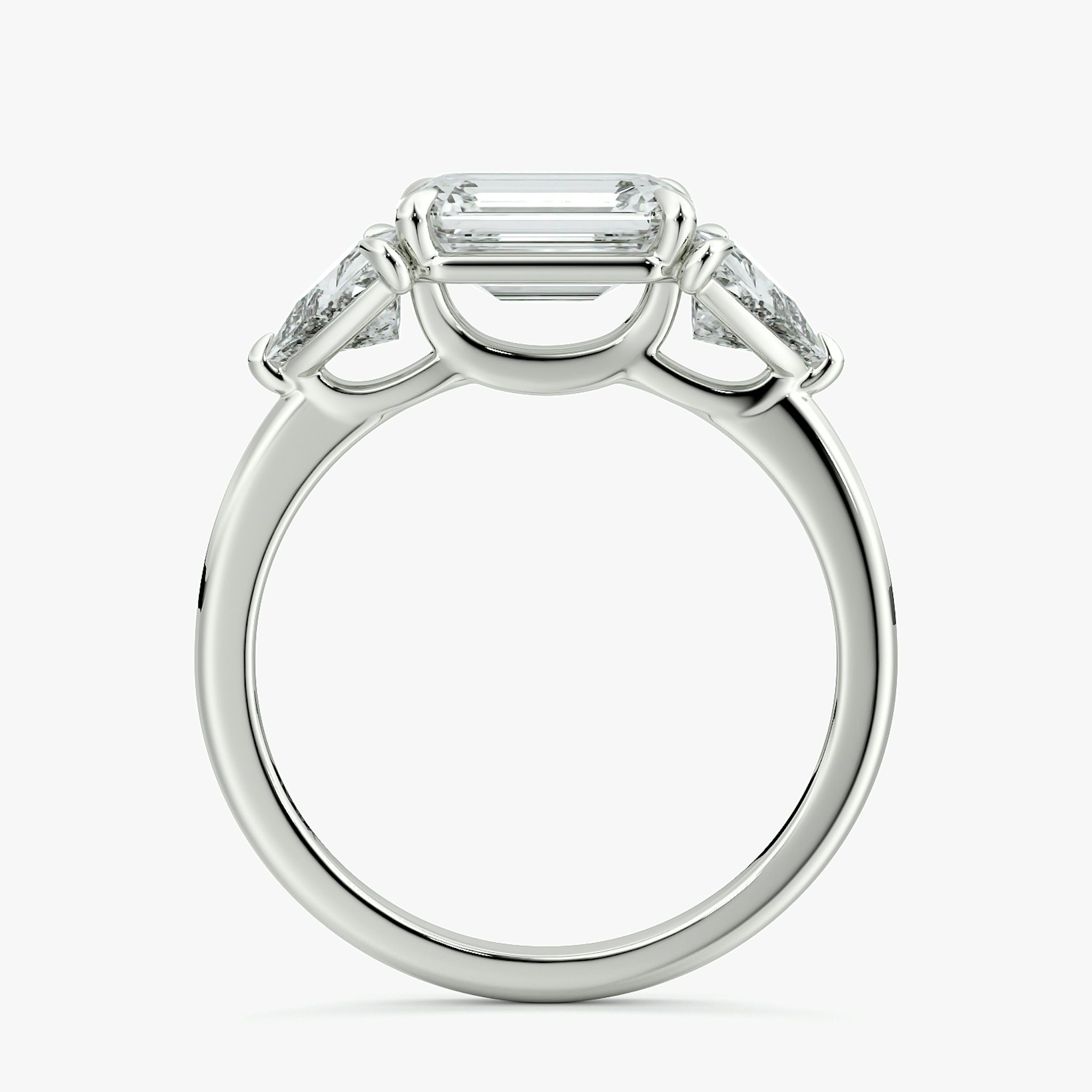 The Three Stone | Emerald | 18k | White Gold | bandAccent: Plain | diamondOrientation: horizontal | sideStoneCarat: 0.50ct | sideStoneShape: Trillion | caratWeight: other