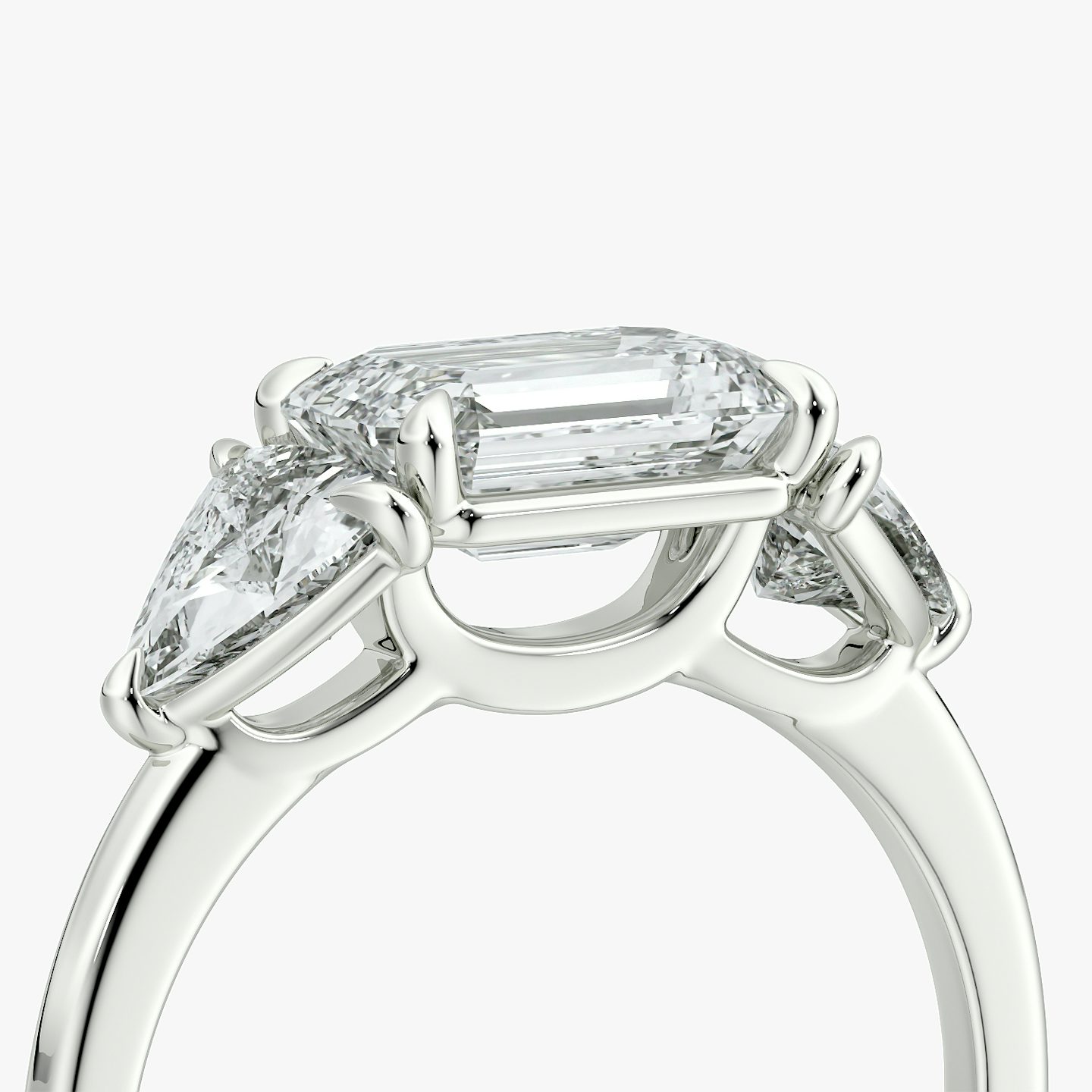 The Three Stone | Emerald | Platinum | bandAccent: Plain | diamondOrientation: horizontal | sideStoneCarat: 0.50ct | sideStoneShape: Trillion | caratWeight: other