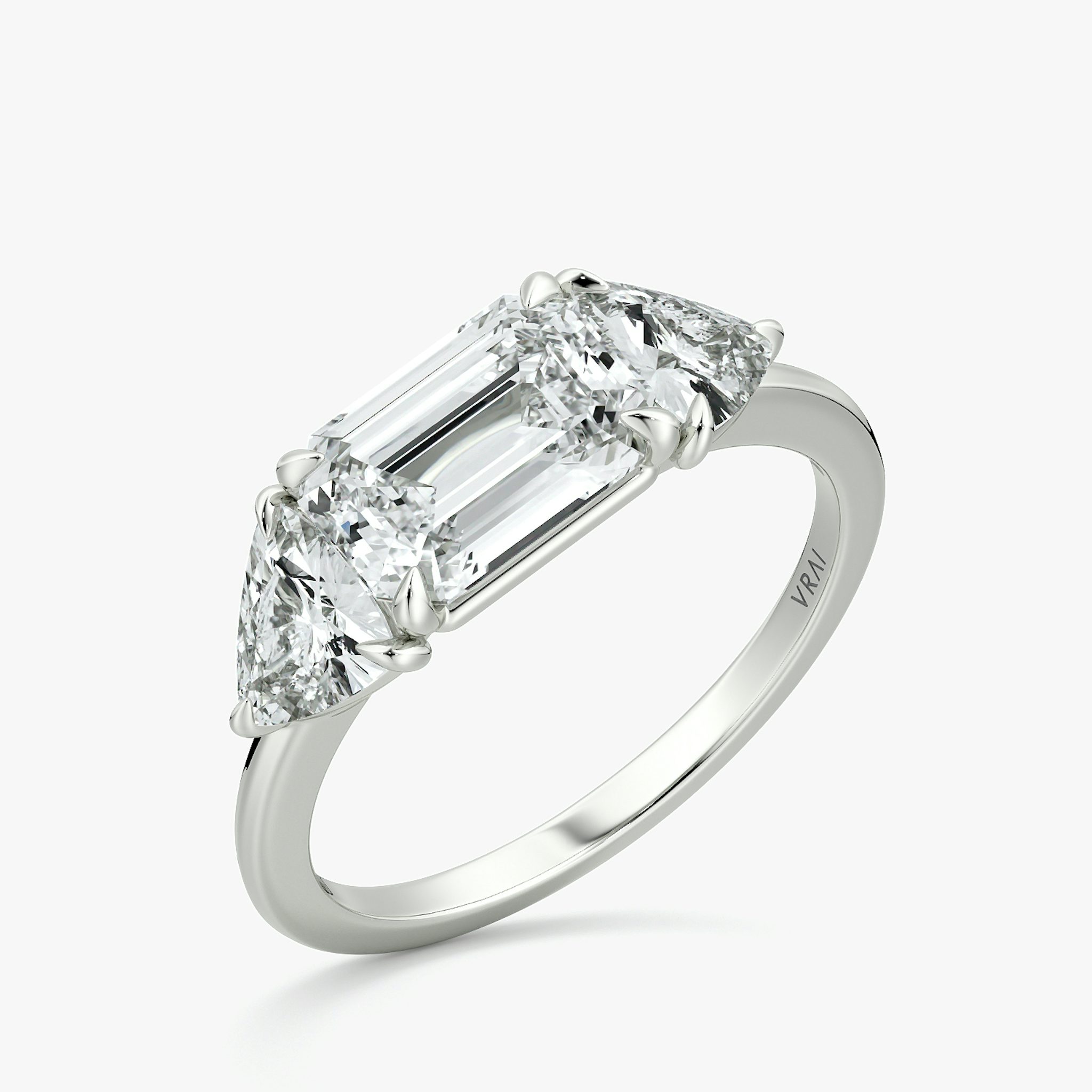 The Three Stone | Emerald | 18k | White Gold | bandAccent: Plain | diamondOrientation: horizontal | sideStoneCarat: 0.50ct | sideStoneShape: Trillion | caratWeight: other