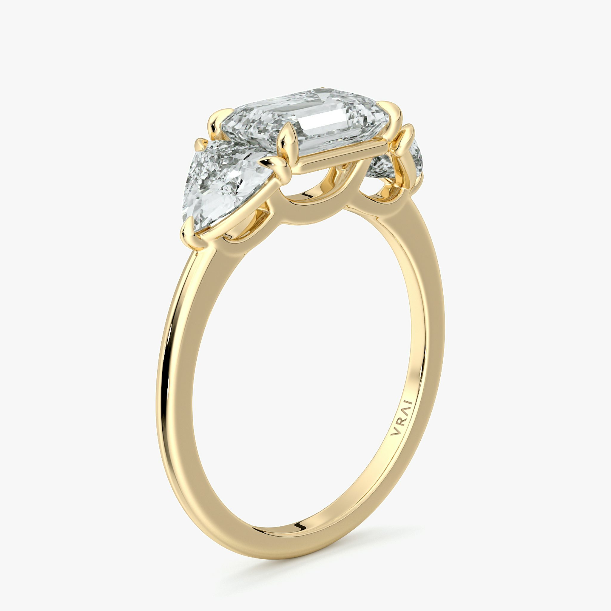 The Three Stone | Emerald | 18k | Yellow Gold | bandAccent: Plain | diamondOrientation: horizontal | sideStoneCarat: 0.50ct | sideStoneShape: Trillion | caratWeight: other