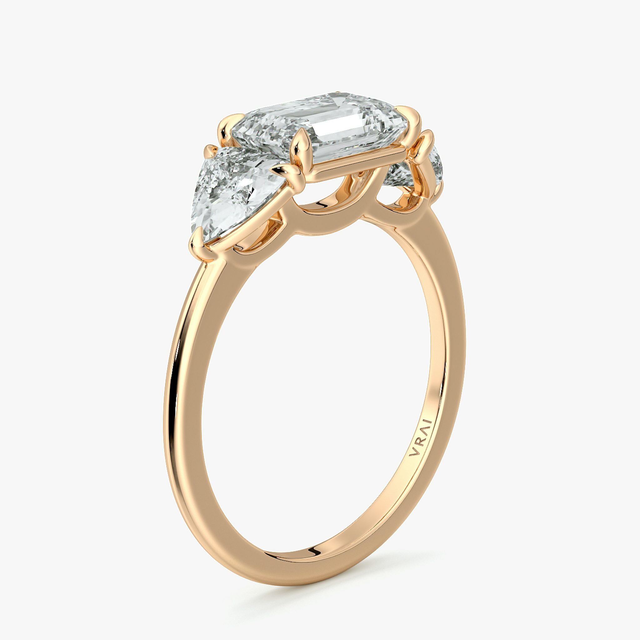 The Three Stone | Emerald | 14k | Rose Gold | bandAccent: Plain | diamondOrientation: horizontal | sideStoneCarat: 0.50ct | sideStoneShape: Trillion | caratWeight: other