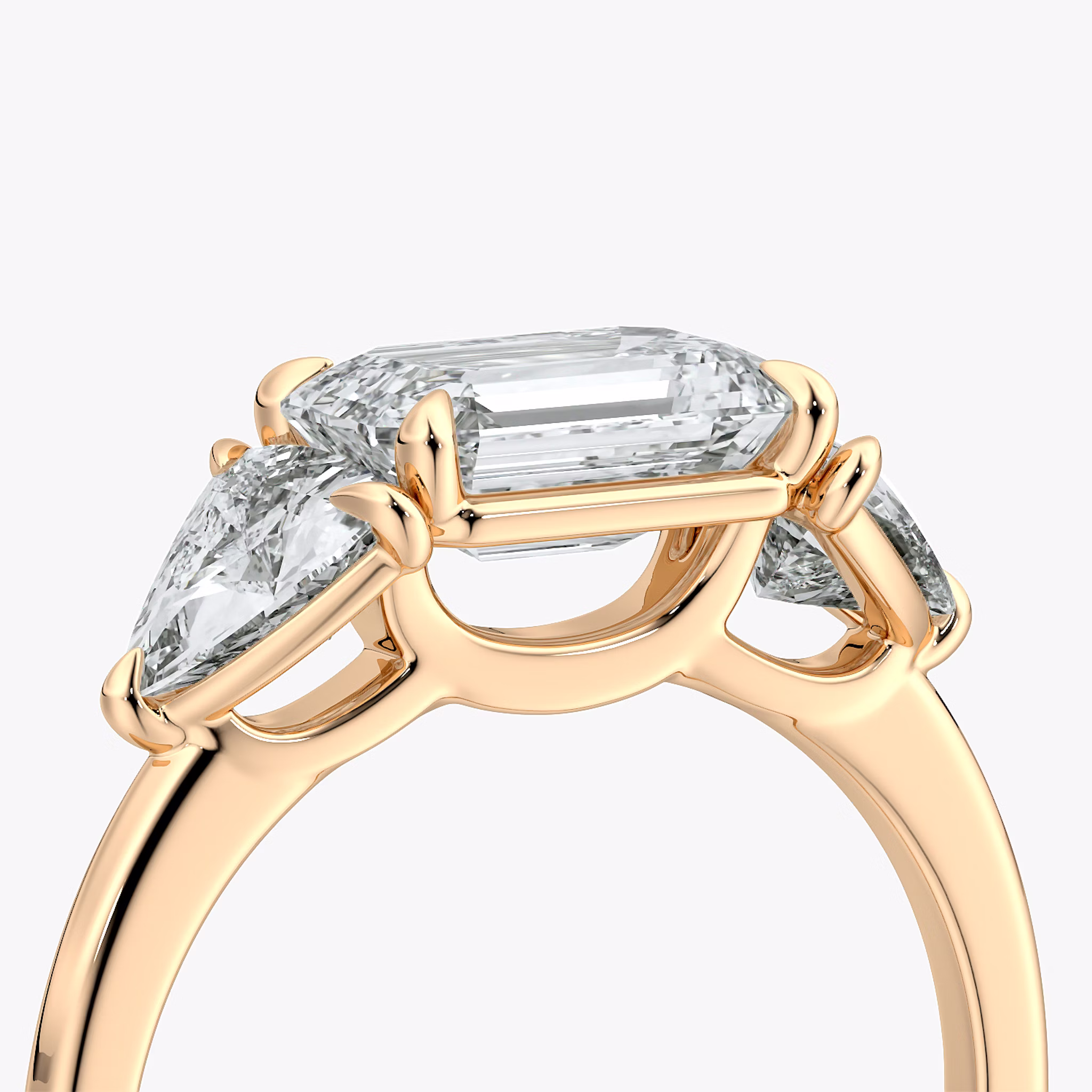 The Three Stone | Emerald | 14k | Rose Gold | bandAccent: Plain | diamondOrientation: horizontal | sideStoneCarat: 0.50ct | sideStoneShape: Trillion | caratWeight: other