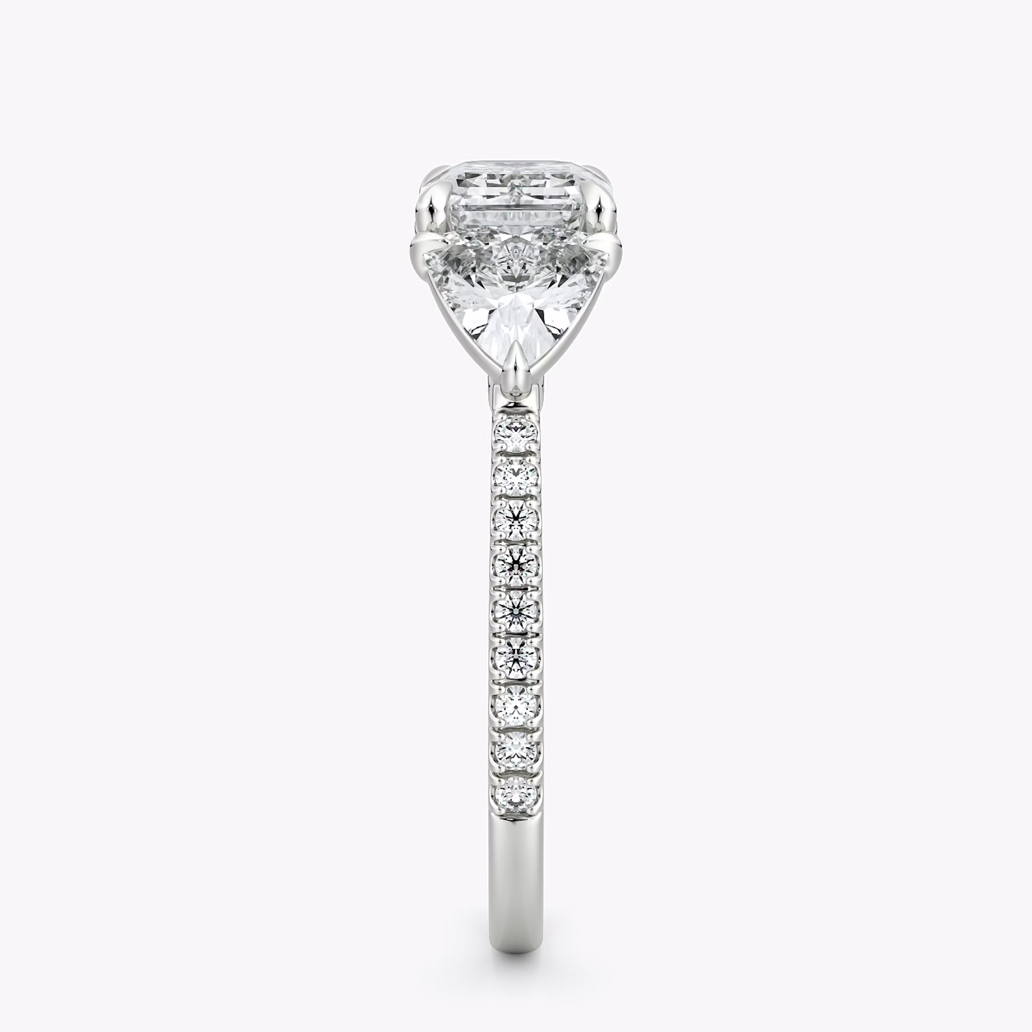 The Three Stone | Emerald | Platinum | bandAccent: Pavé | diamondOrientation: horizontal | sideStoneCarat: 0.50ct | sideStoneShape: Trillion | caratWeight: other