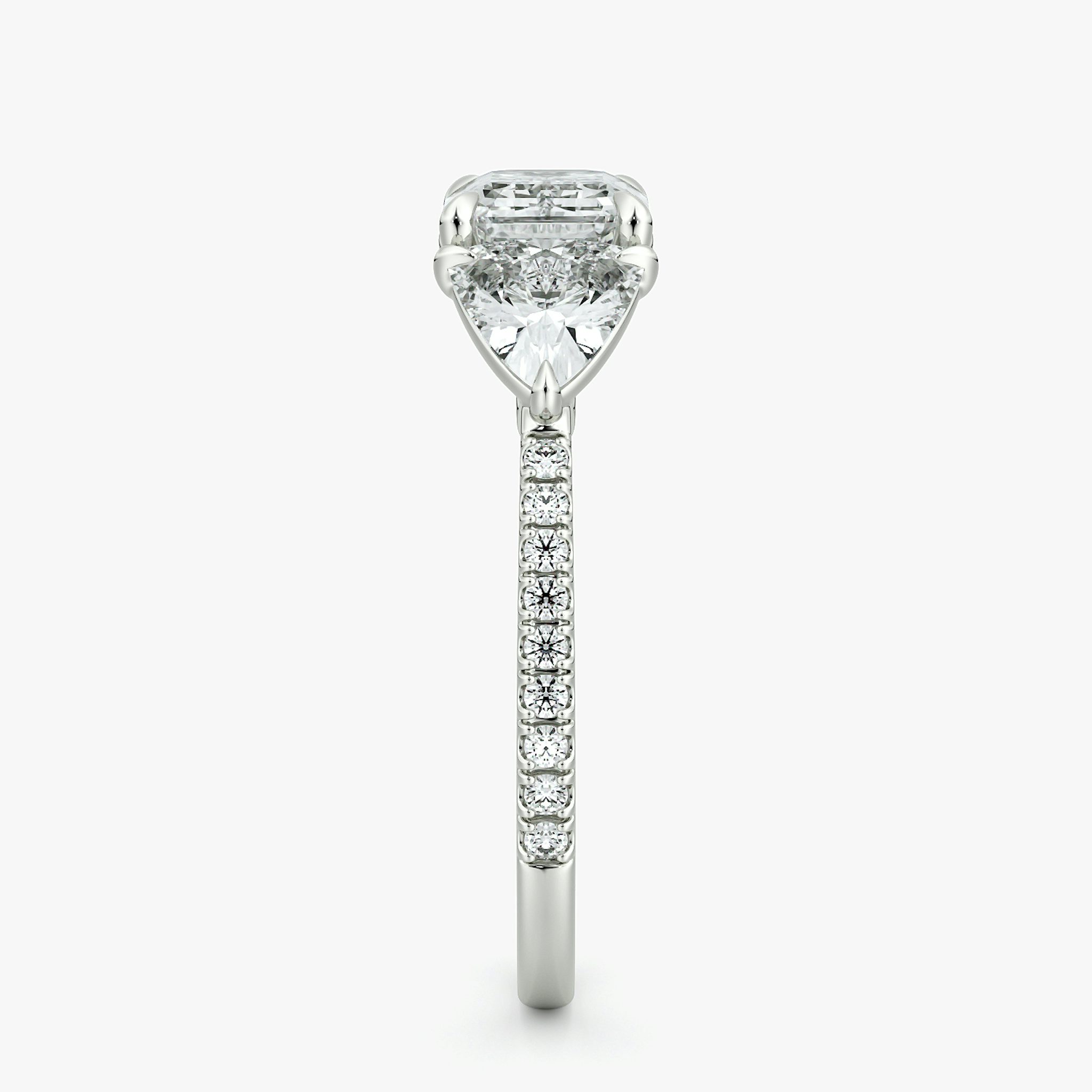 The Three Stone | Emerald | Platinum | bandAccent: Pavé | diamondOrientation: horizontal | sideStoneCarat: 0.50ct | sideStoneShape: Trillion | caratWeight: other