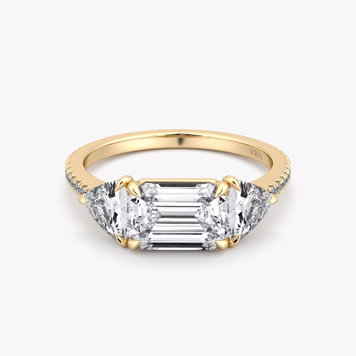 The Three Stone | Emerald | 18k | Yellow Gold | bandAccent: Pavé | diamondOrientation: horizontal | sideStoneCarat: 0.50ct | sideStoneShape: Trillion | caratWeight: other
