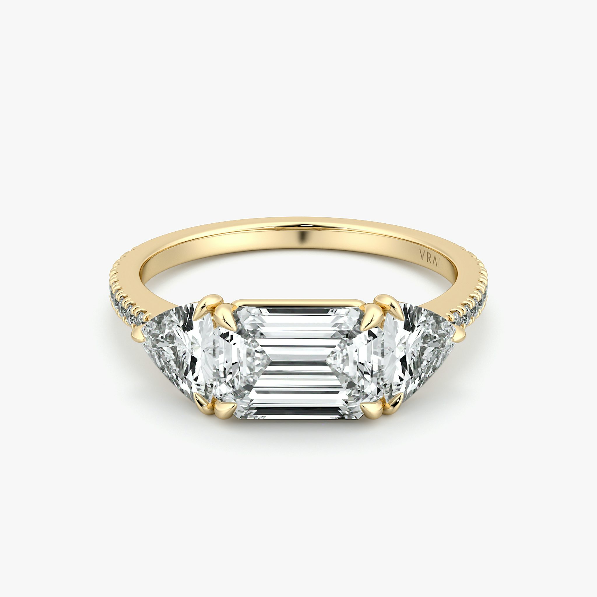 The Three Stone | Emerald | 18k | Yellow Gold | bandAccent: Pavé | diamondOrientation: horizontal | sideStoneCarat: 0.50ct | sideStoneShape: Trillion | caratWeight: other