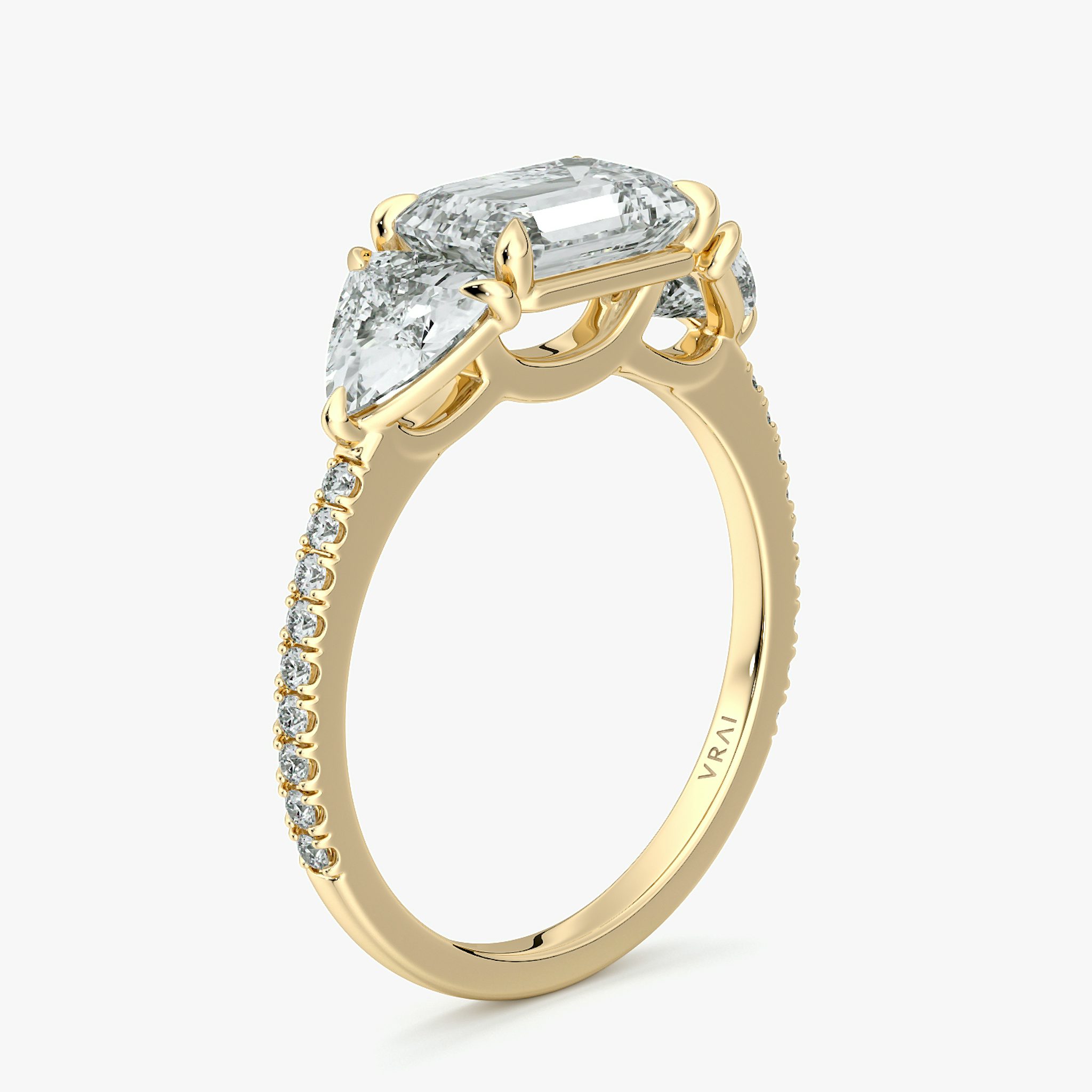 The Three Stone | Emerald | 18k | Yellow Gold | bandAccent: Pavé | diamondOrientation: horizontal | sideStoneCarat: 0.50ct | sideStoneShape: Trillion | caratWeight: other