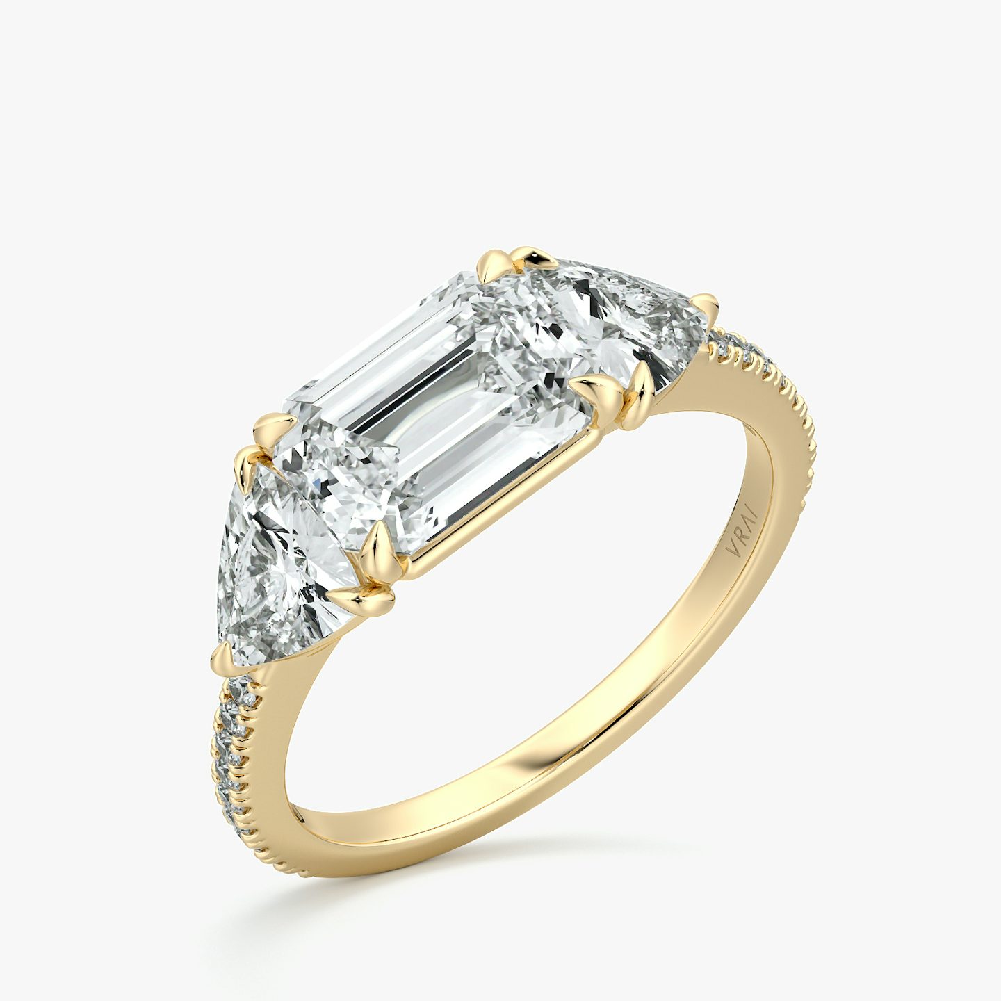 The Three Stone | Emerald | 18k | Yellow Gold | bandAccent: Pavé | diamondOrientation: horizontal | sideStoneCarat: 0.50ct | sideStoneShape: Trillion | caratWeight: other