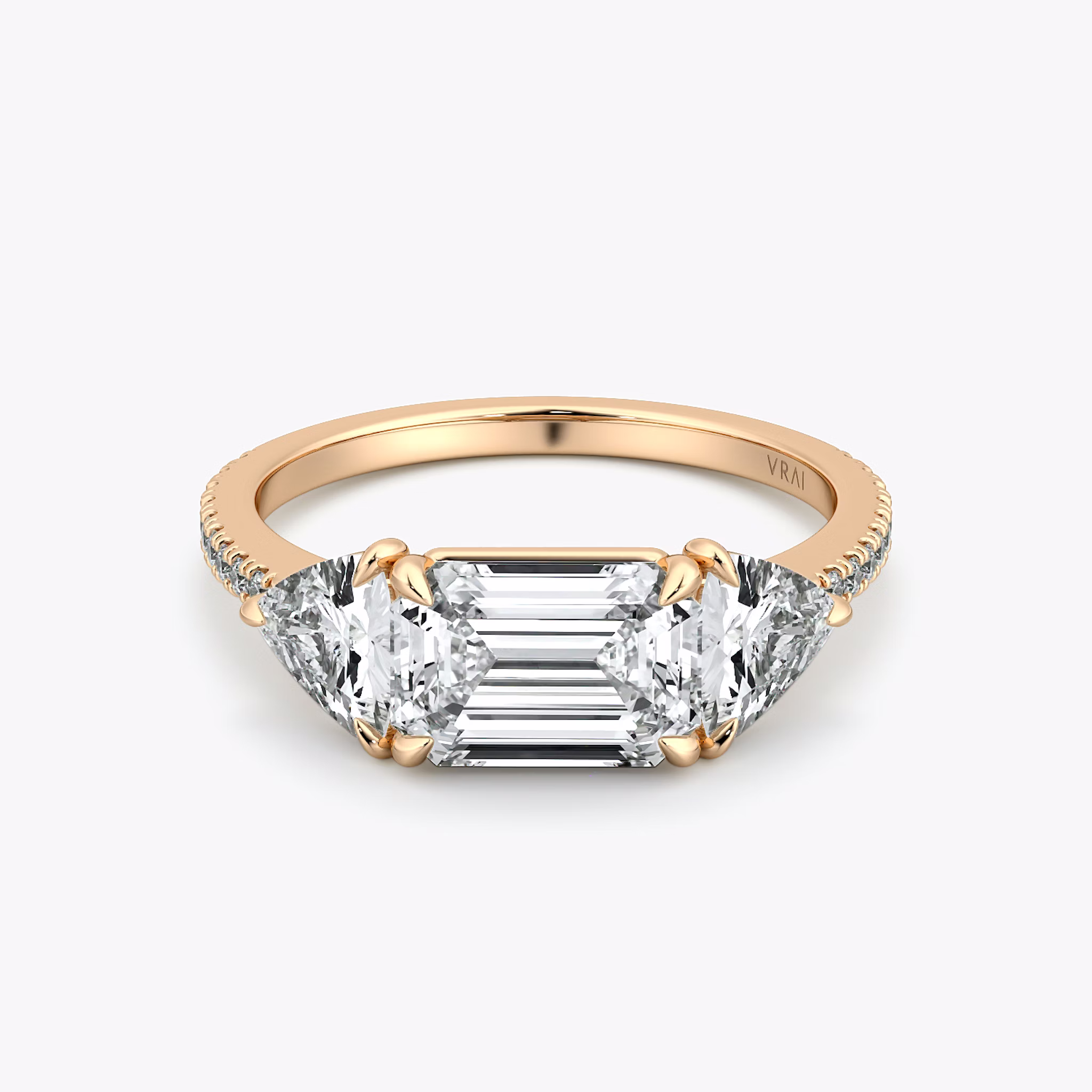 The Three Stone | Emerald | 14k | Rose Gold | bandAccent: Pavé | diamondOrientation: horizontal | sideStoneCarat: 0.50ct | sideStoneShape: Trillion | caratWeight: other