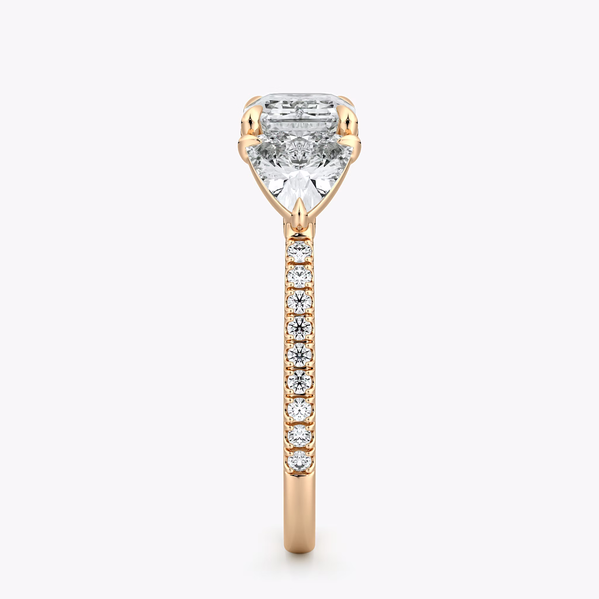 The Three Stone | Emerald | 14k | Rose Gold | bandAccent: Pavé | diamondOrientation: horizontal | sideStoneCarat: 0.50ct | sideStoneShape: Trillion | caratWeight: other